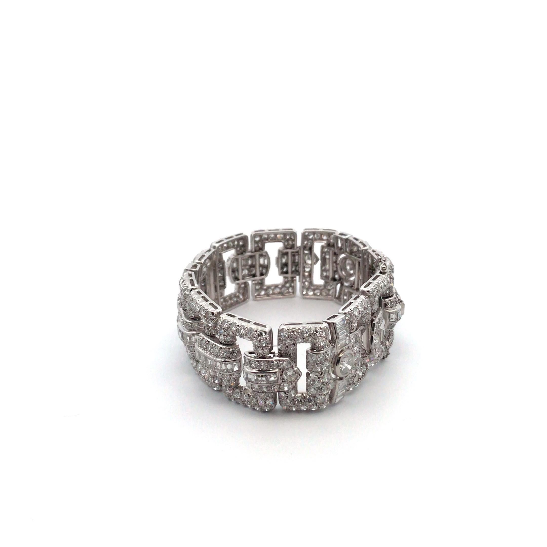 Diamond Art Deco Bracelet weighing 64.3 grams, 7 inches in length and 0.80 inches in width. The bracelet is further enhanced with a total of 521 Round Brilliant Cut diamonds and 64 Baguette cut diamonds, well matched, 
Color Range of: G-H, Clarity