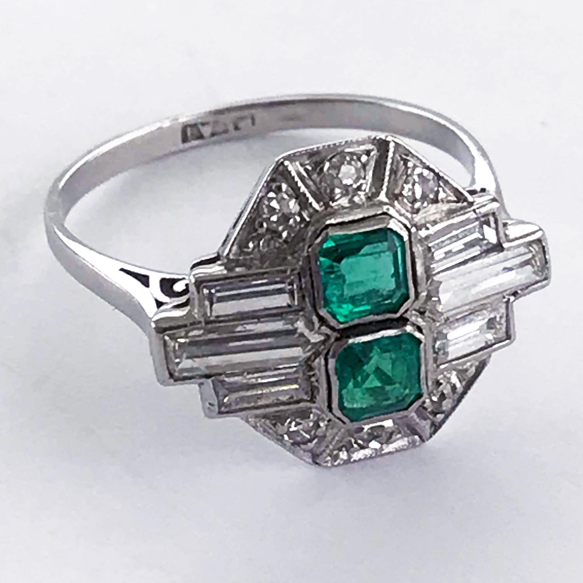 Platinum Art Deco Emerald and Diamond, vintage ring, handmade in England circa 1920.

Central emeralds 0.70 carats (total), Columbian, natural untreated colour with very minor inclusions. 

The emeralds surrounded by differing cuts of diamonds