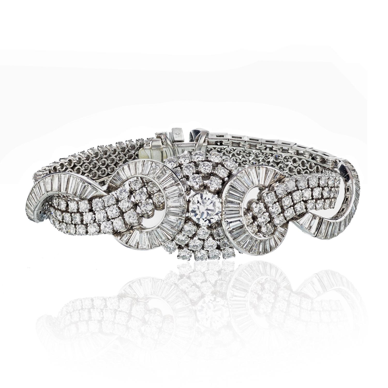 Crafted with unparalleled artistry and adorned with the most exquisite diamonds, our Art Deco Platinum Cluster Diamond 38.00cttw Bracelet is a testament to timeless elegance. Every aspect of this remarkable piece is a celebration of beauty and