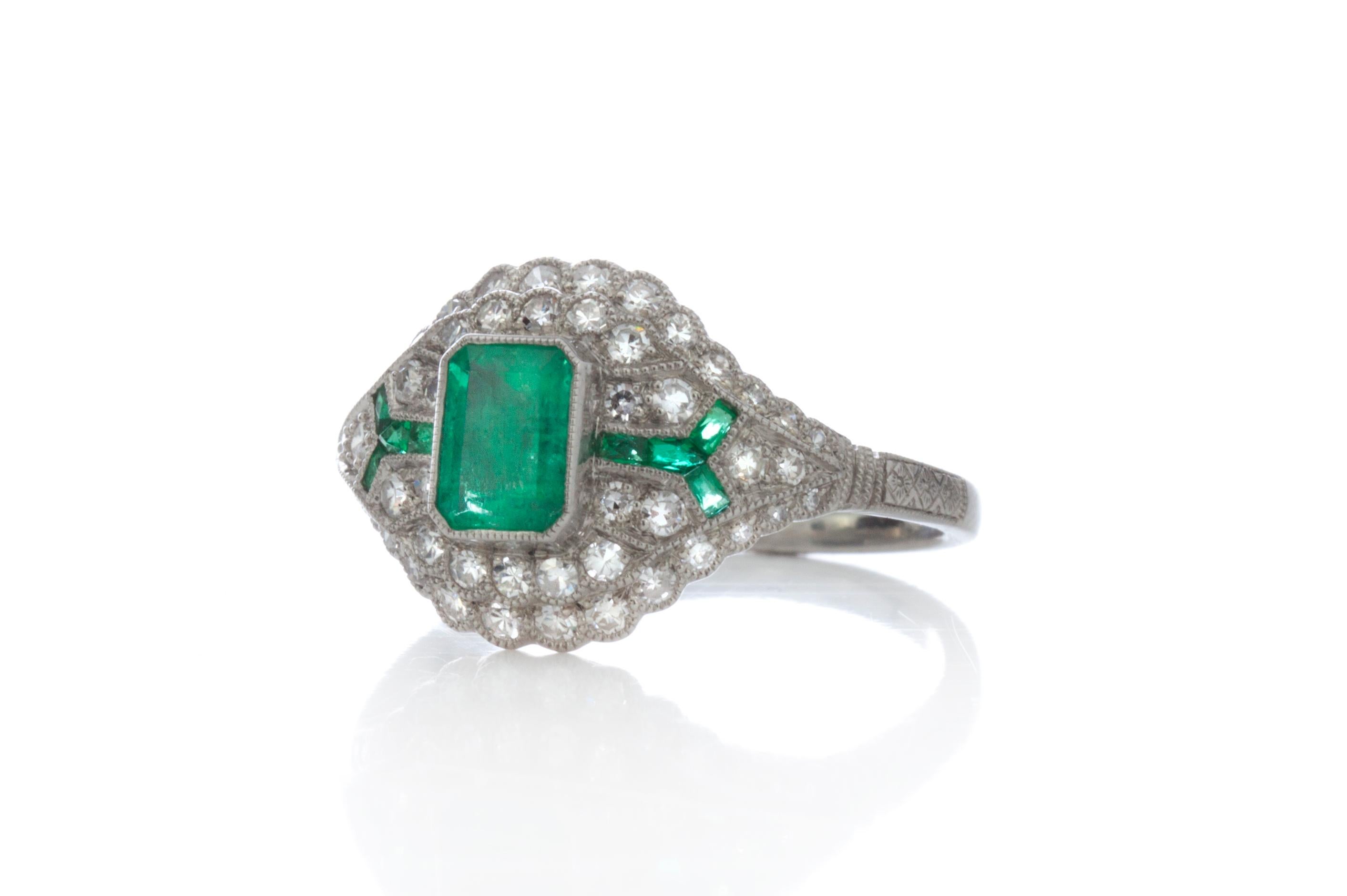 Platinum art deco inspired emerald and diamond ring
Made in 1980's
Ring is hallmarked PLAT (.950 platinum purity_=)
Hallmarked 0.55 ct for Emerald weight

Dimensions - 
Ring Size (UK) = N (EU) = 54 (US) = 7
Weight: 4.65 grams
Size: 2.5 x 2 x 1.2