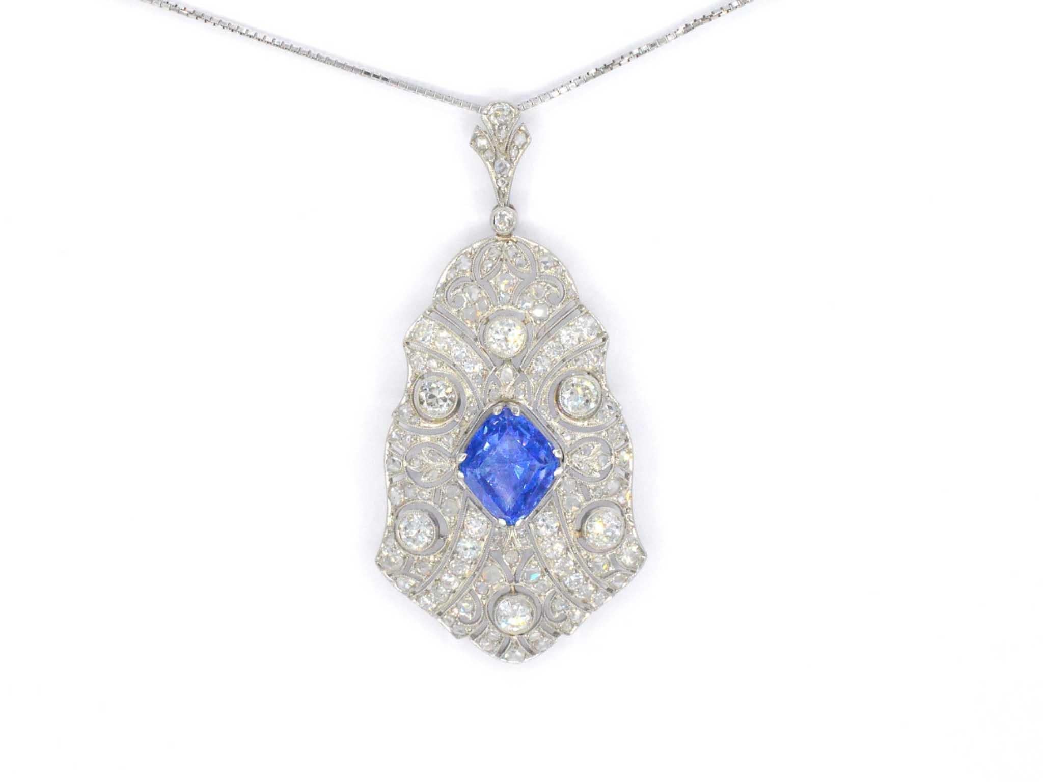 This exquisite pendant features a harmonious blend of vintage elegance and luxurious craftsmanship. At its center, a 3.00-carat natural diamond in an antique cut displays a captivating F-G color grade with SI clarity, enhanced by a very good cut