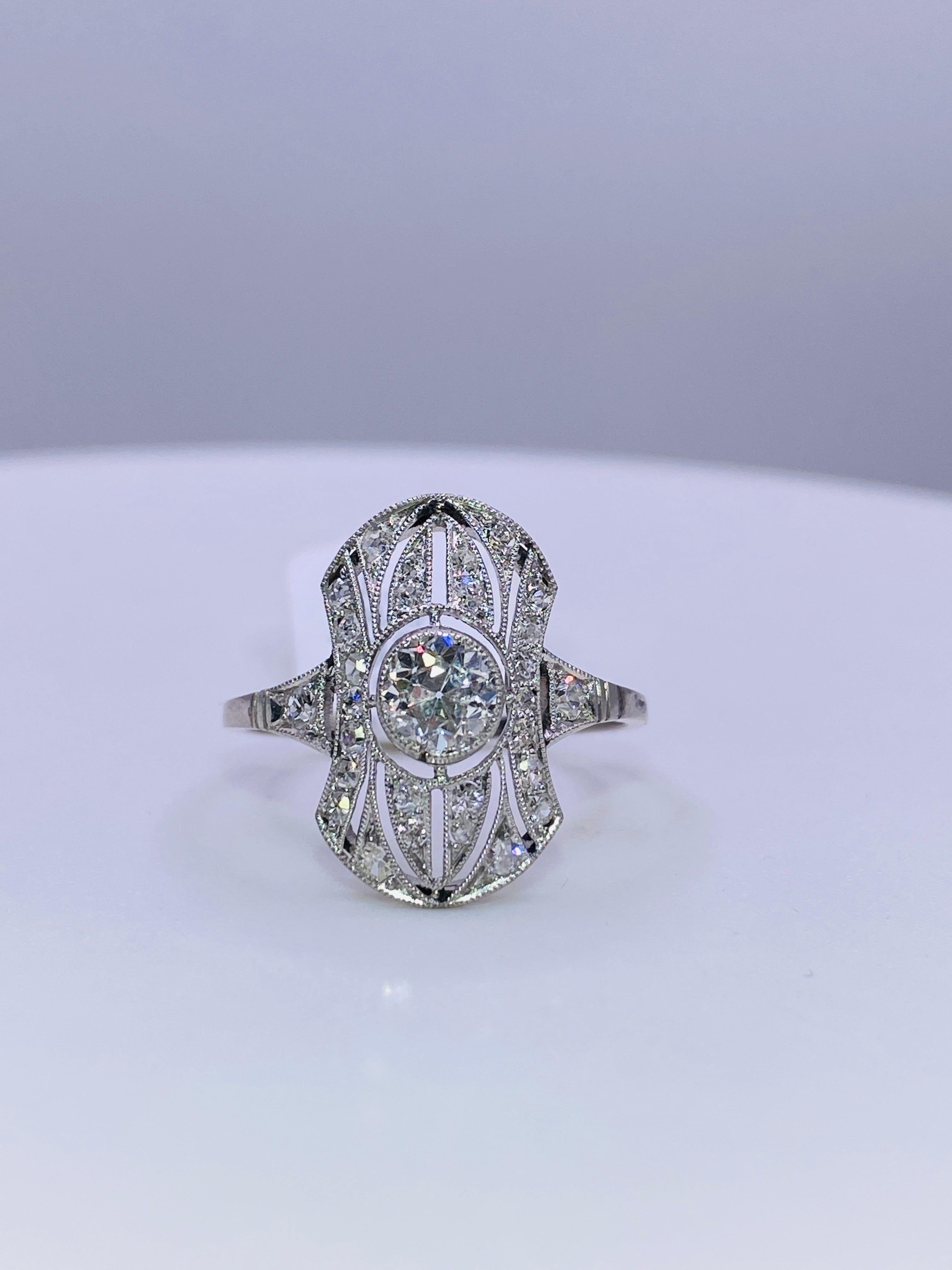 Platinum Art Deco Ring with .52 carat Old European Cut center diamond and .27 carat total weight smaller diamonds. Size 7.5+

