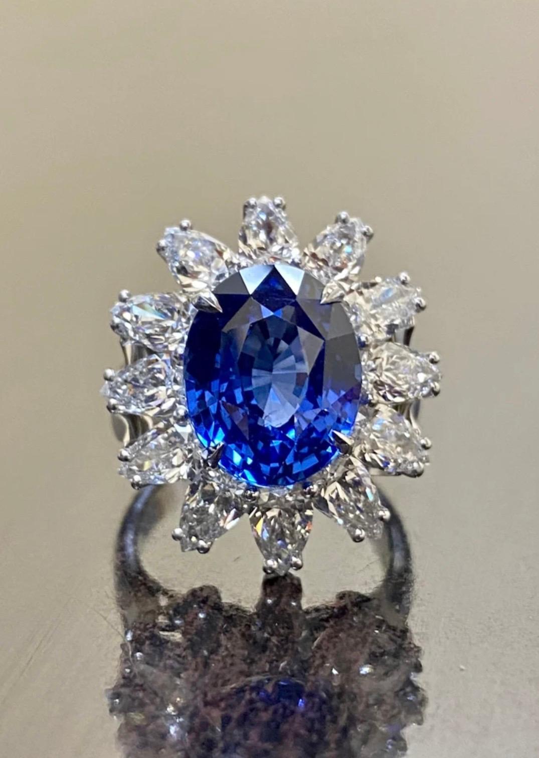 DeKara Designs Collection Masterpiece

Beautiful Modern/Art Deco Ceylon Blue Sapphire and Diamond Ring

Metal- 90% Platinum, 10% Iridium.

Stones- GIA Certified Ceylon/Sri Lanka Oval Blue Sapphire 8.59 Carats, 12 Pear Shape Diamonds E-F Color