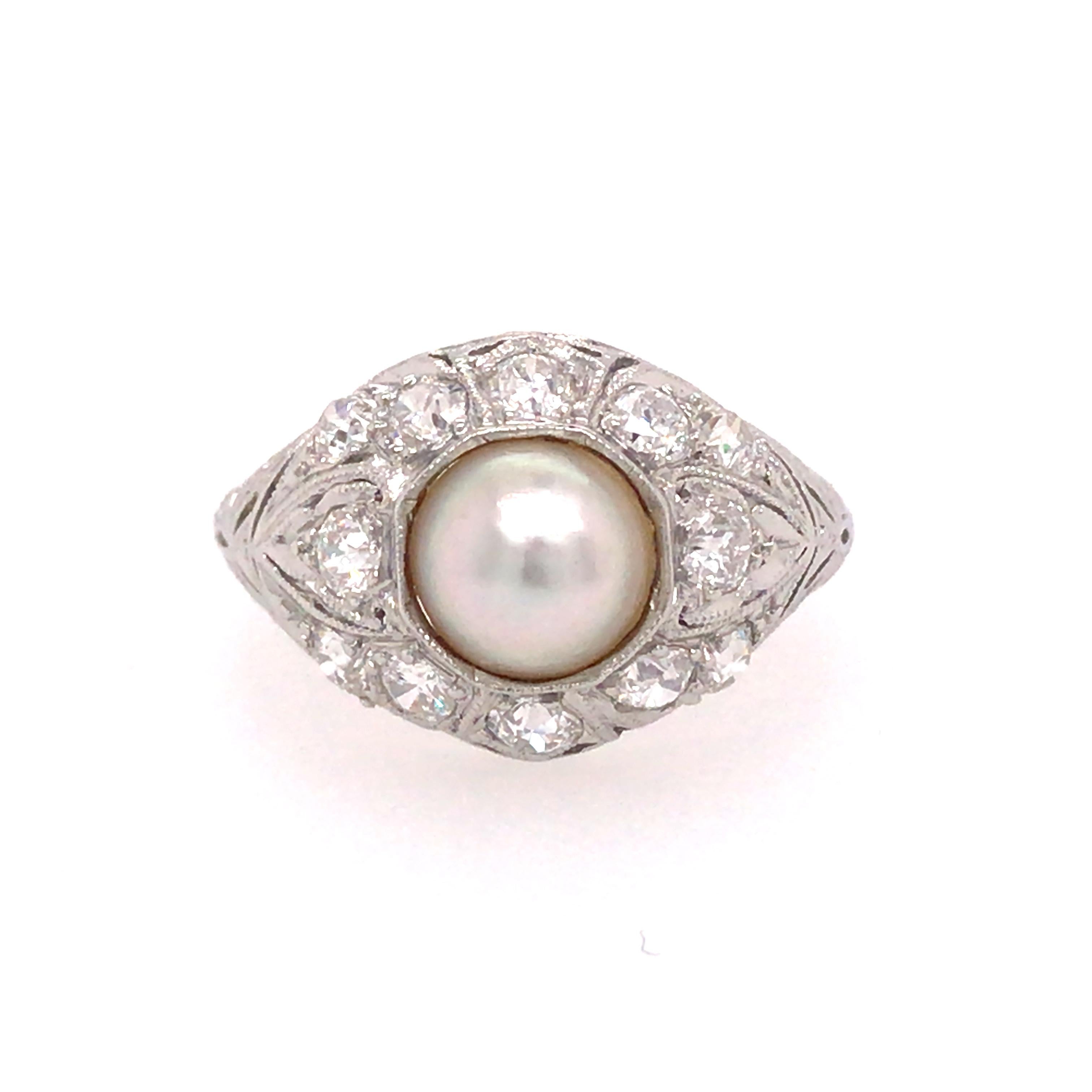Art Deco Pearl Diamond Ring in Platinum.  Round Brilliant Cut Diamonds weighing 0.72 carat total weight, G-H in color and VS in clarity are expertly set around the Round White Pearl.  The Ring measures 1/2 inch in width.  Ring size 4. 3.88 grams. 