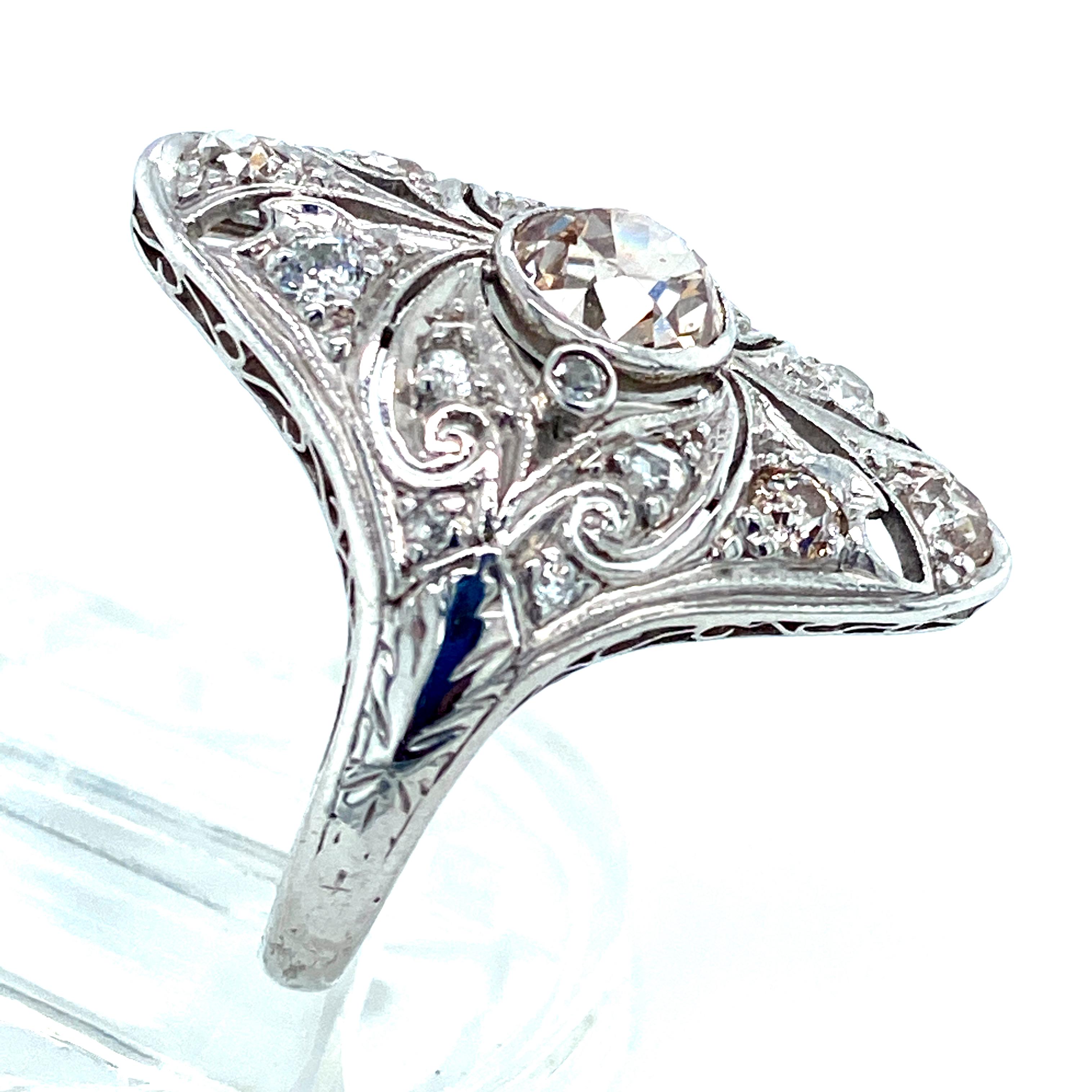 Original Art Deco diamond ring in platinum. The center diamond is a light pinkish-brown weighing approximately .83 carats wtih SI clarity. The other diamonds in the ring are Old European cuts and all the diamonds weigh a total of 1.25 cts with