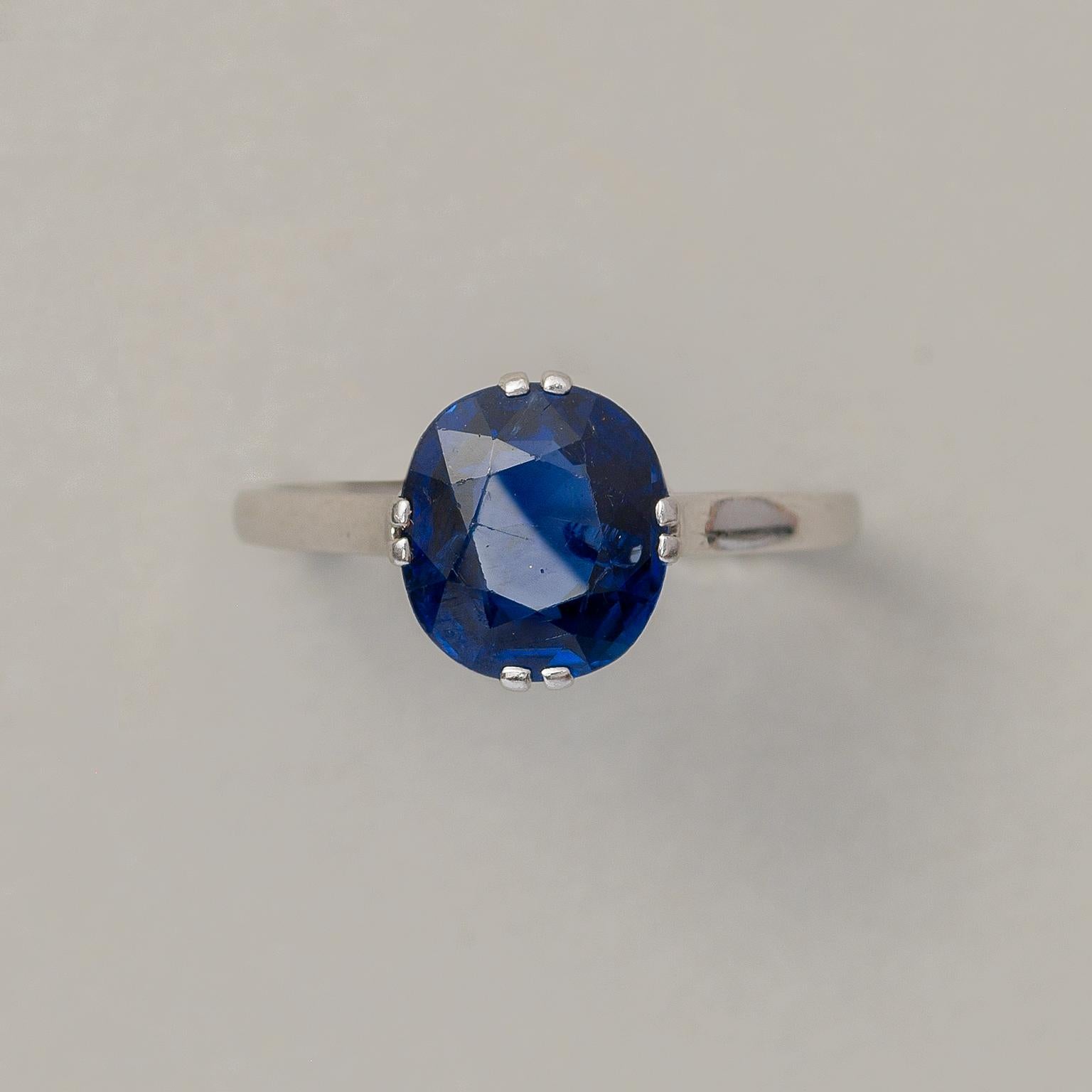 A platinum ring with a deep blue cushion cut natural untreated Burma sapphire (approx. 2.85 carat and 9.3 x 8.3 x 4.1 mm) set in a double prong setting, France, circa 1920.

weight: 3.14 grams
ring size: 18 mm / 8 US
