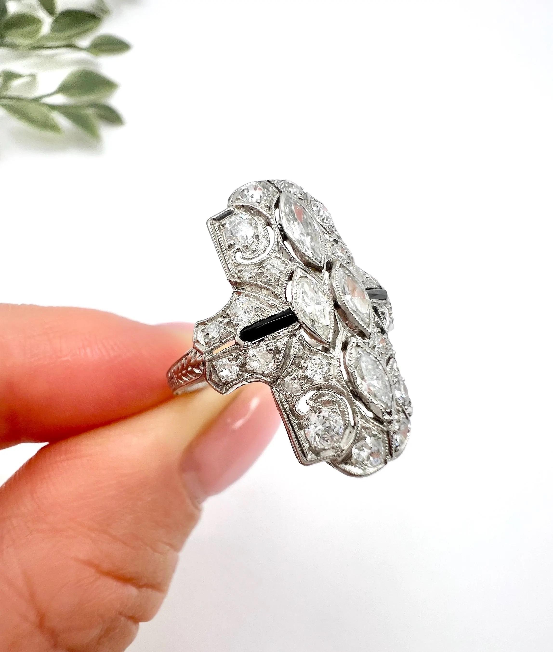 Deco Style Shield Ring

Platinum Tested

Circa 2000

Introducing our exquisite Platinum Art Deco Style Shield Ring, crafted circa 2000. This stunning piece features a distinctive shield-shaped design, elegantly set with both marquise and