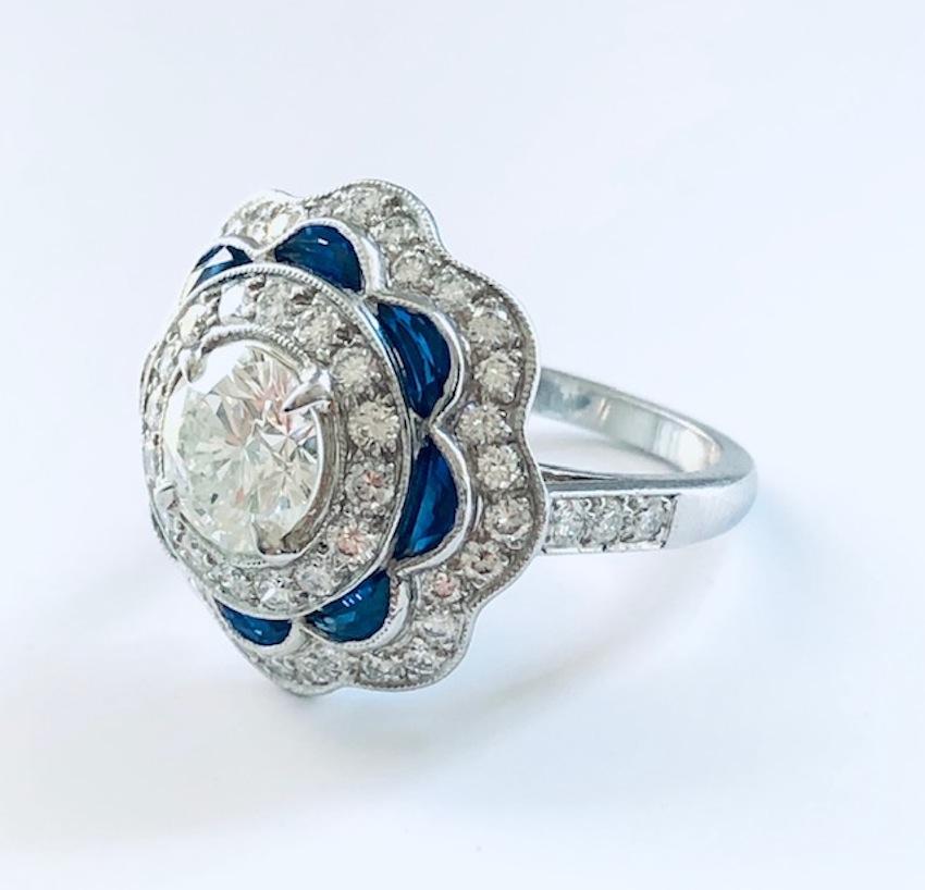 Beautiful Art deco design Ring made in Platinum, set with a round center Diamond 1.27 carats, 54 round diamonds 1.00 carat and 8 custom cut half moon Sapphires 1.68 carats, great looking and beautiful on the finger !

We design and manufacture all