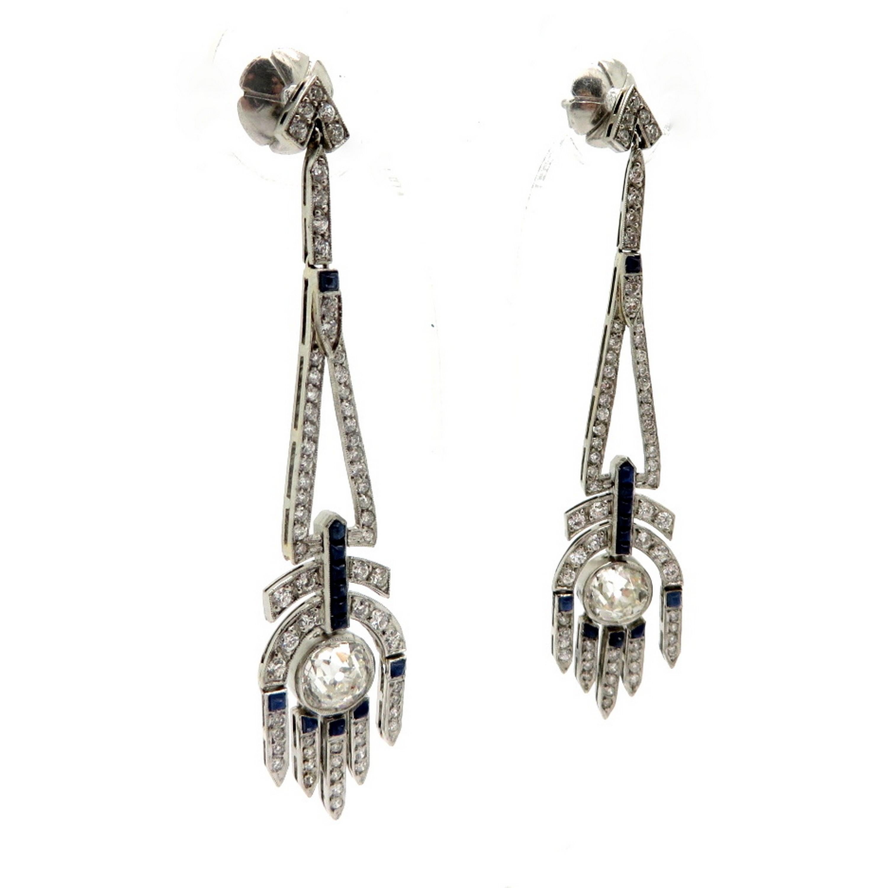 Platinum Art Deco style Old mine cut diamond and sapphire dangle earrings. Showcasing 2 Old Mine cut diamonds weighing a total of 2.20 carats. Diamond grading: color grade: H. Clarity grade: SI1. Interspersed with 132 Old European cut diamonds
