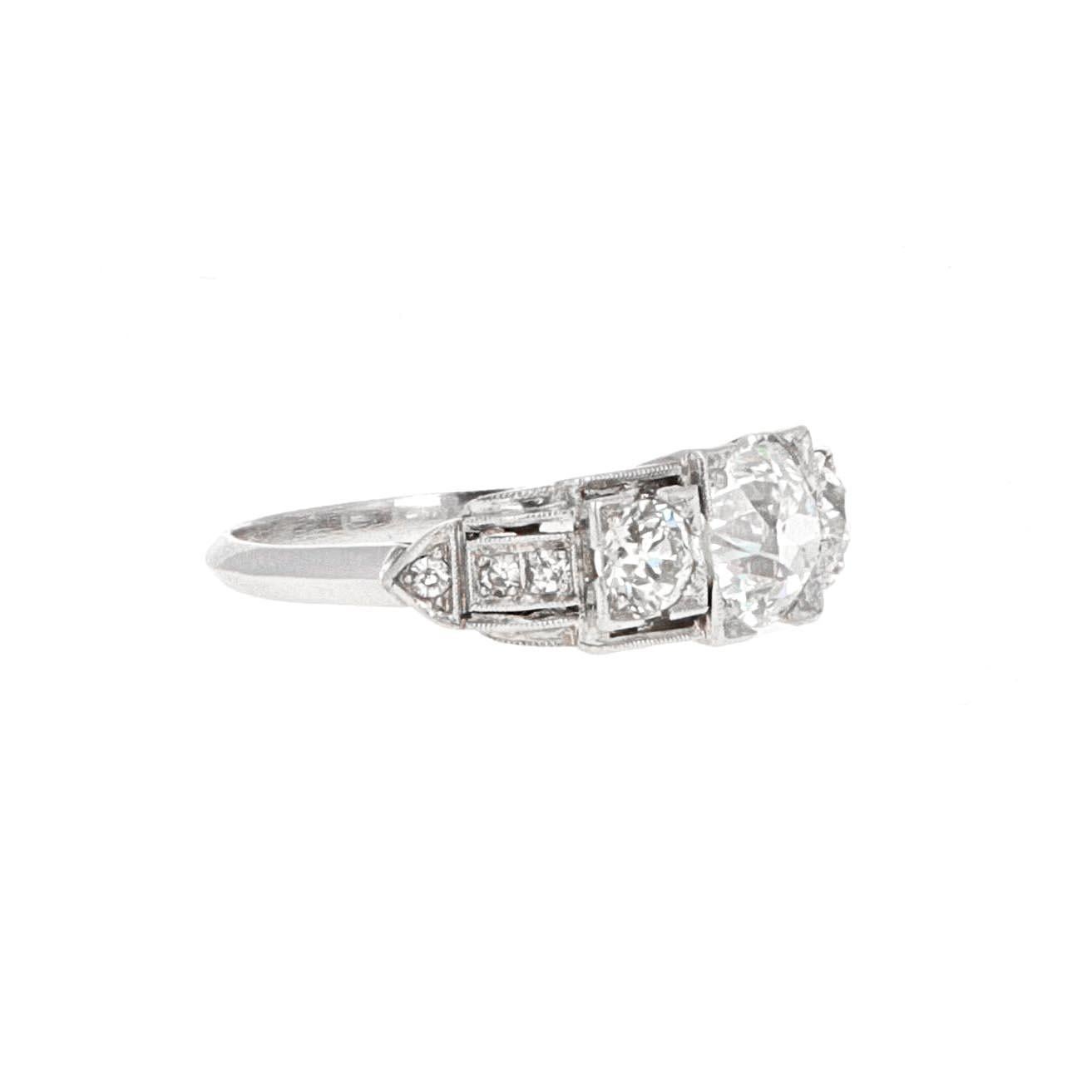 Platinum art deco three-stone diamond ring. The ring has a center diamond weighing 1.16 carats. The center stone is  an old european cut diamond. 
The ring is in excellent condition