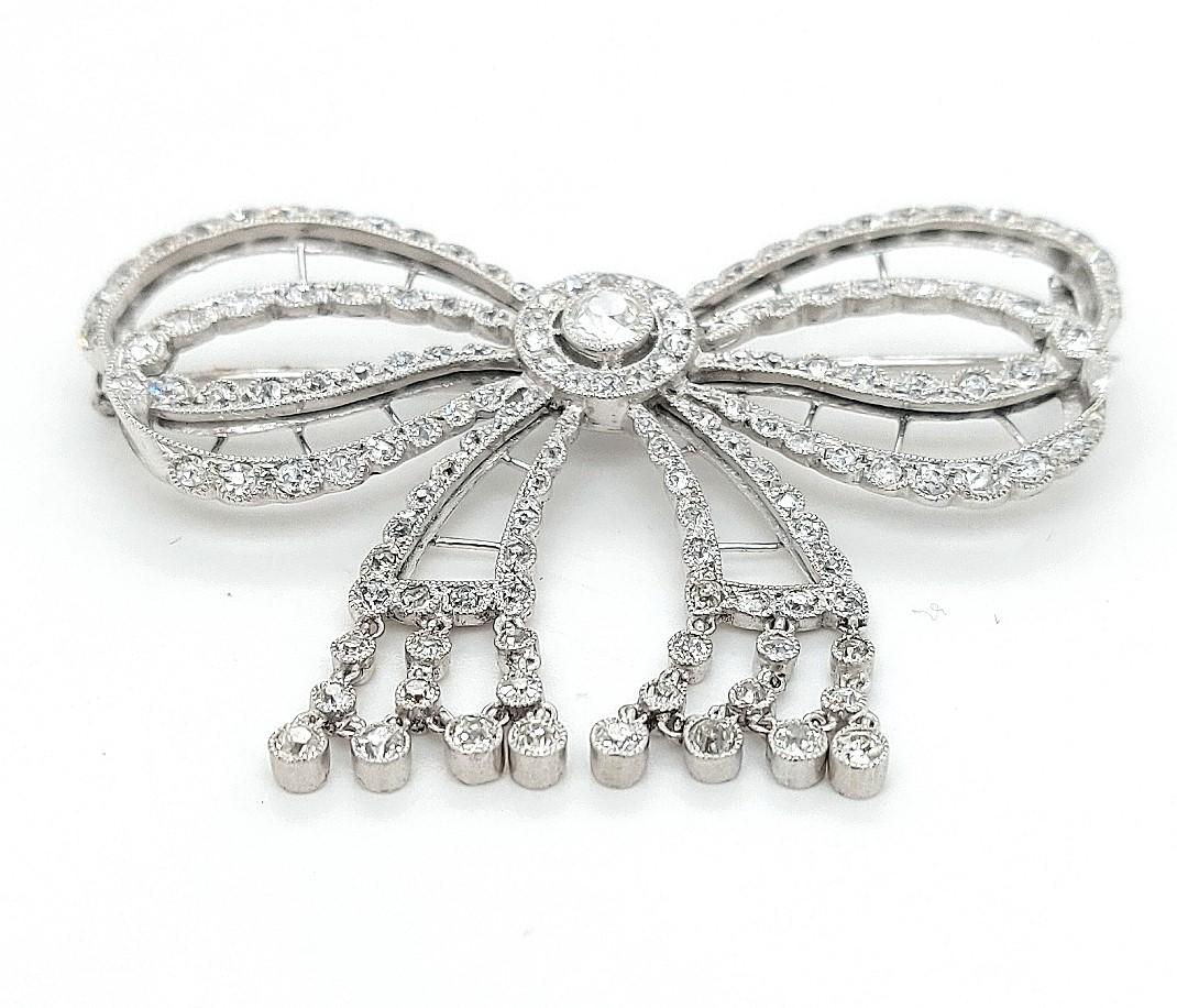Round Cut Platinum Artdeco Bowknot Diamond Brooch with Dangling Diamonds For Sale