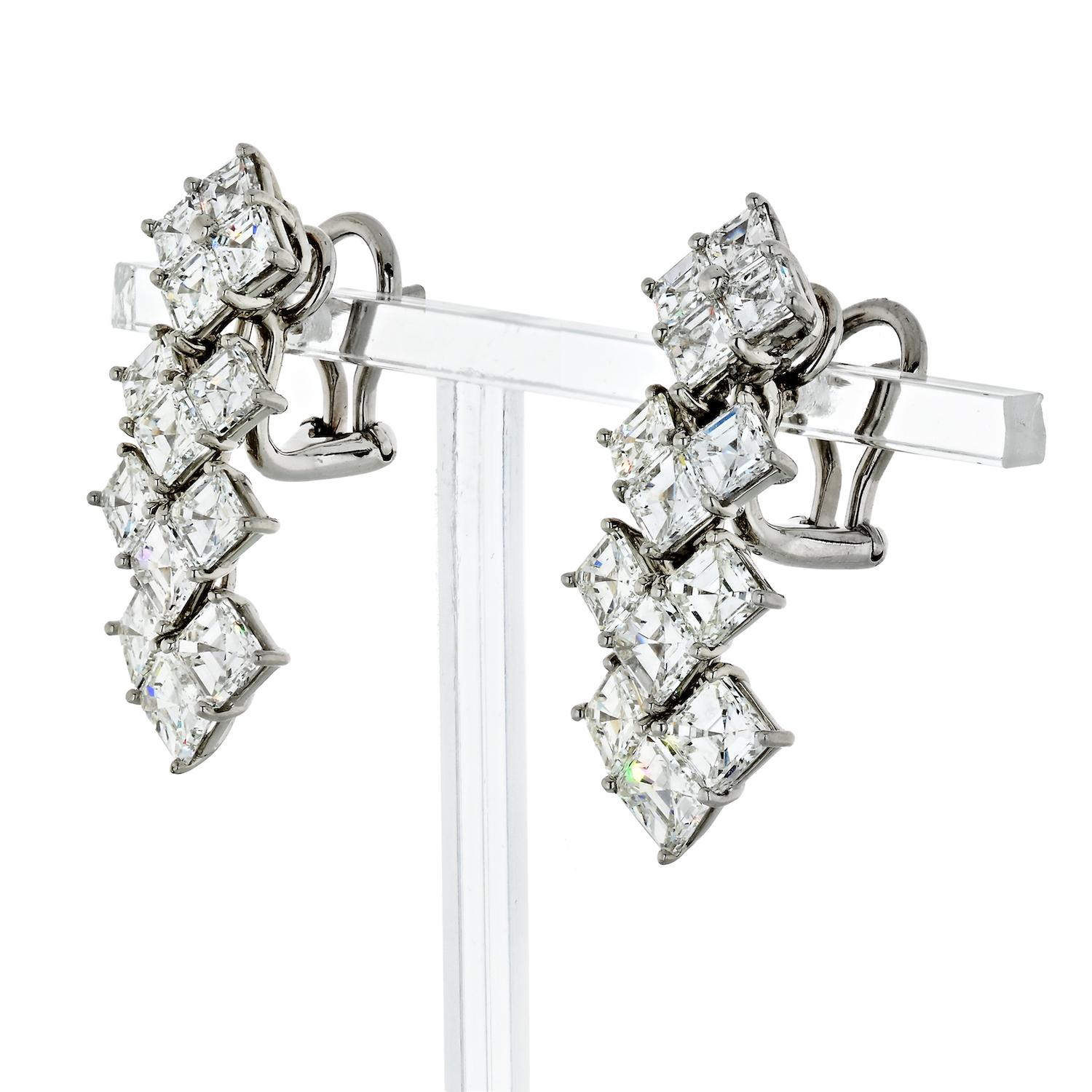 These fine earrings feature 26 white dazzling asscher-cut diamonds. Created in platinum the earrings are thoughtfully designed with an Art Deco flare. These earrings measure approximately 29 mm long and 12mm wide. 
Post with an omega backing. 
26