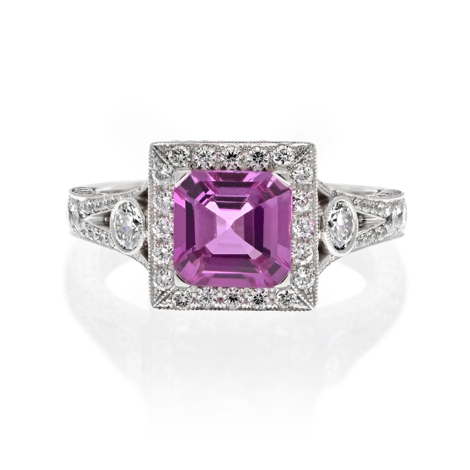The Perfect Pink: Platinum Pink Sapphire Halo Engagement Ring.

At the heart of this ring is an Asscher cut pink sapphire, weighing 1.53 carats. This pink sapphire boasts a captivating pink hue, a symbol of love and romance. Held in a prong setting,