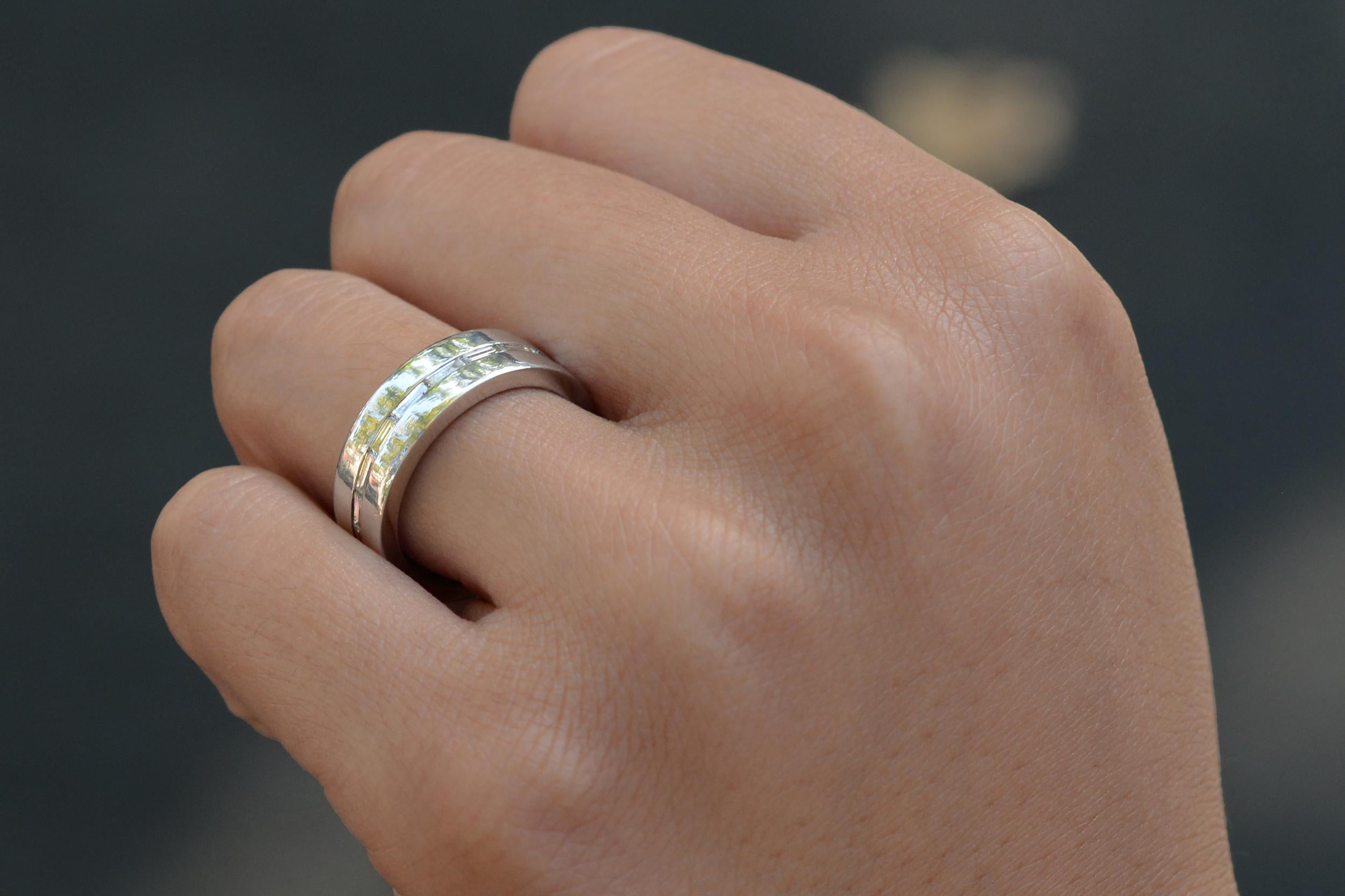 A tasteful vintage wedding band ring, with streamlined baguette cut diamonds perfectly aligned around the 1/4