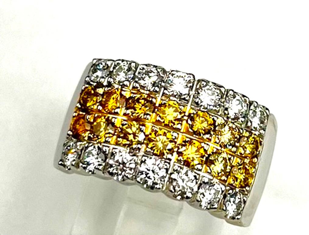 This is an elegant and classic 4 Row Band set with round natural yellow and natural white diamonds. The band has 14 Natural Round Yellow Diamonds of 1.05Ct Total Weight and 14 Round Natural White Diamonds of .91Ct Total Weight. The hue and
