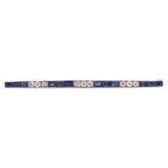 Platinum bar brooch set with sapphires and diamonds 