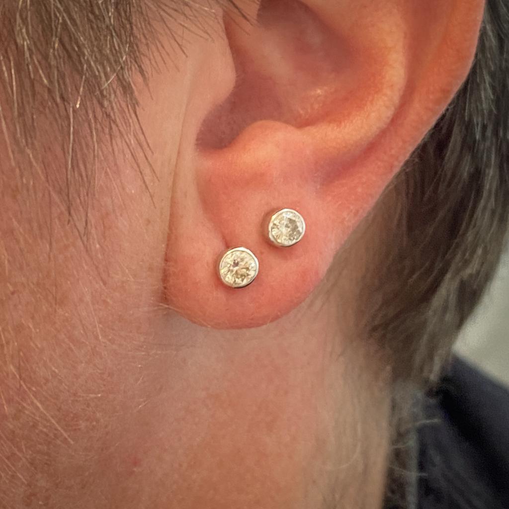 Add a a dash of minimalist elegance to your ears with these fabulous hypoallergenic diamond stud earrings! Platinum bezels securely wrap around beautiful I-J color diamonds. Your special someone will love the elegantly smooth and clean lines of