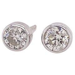 Boucles d'oreilles solitaires en platine avec lunette et diamant de 0,70 carats, montants et dos en or blanc 18 carats