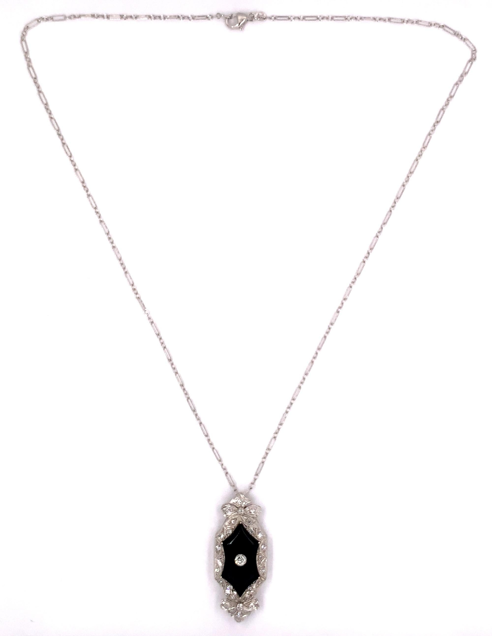 Platinum black onyx and diamond pendant with 14K white gold fancy Deco link chain. The center European cut diamond measures about 3mm and weighs .14cts. There are 26 small round mine cut side diamond weighing about 1/3ct total. The pendant is a