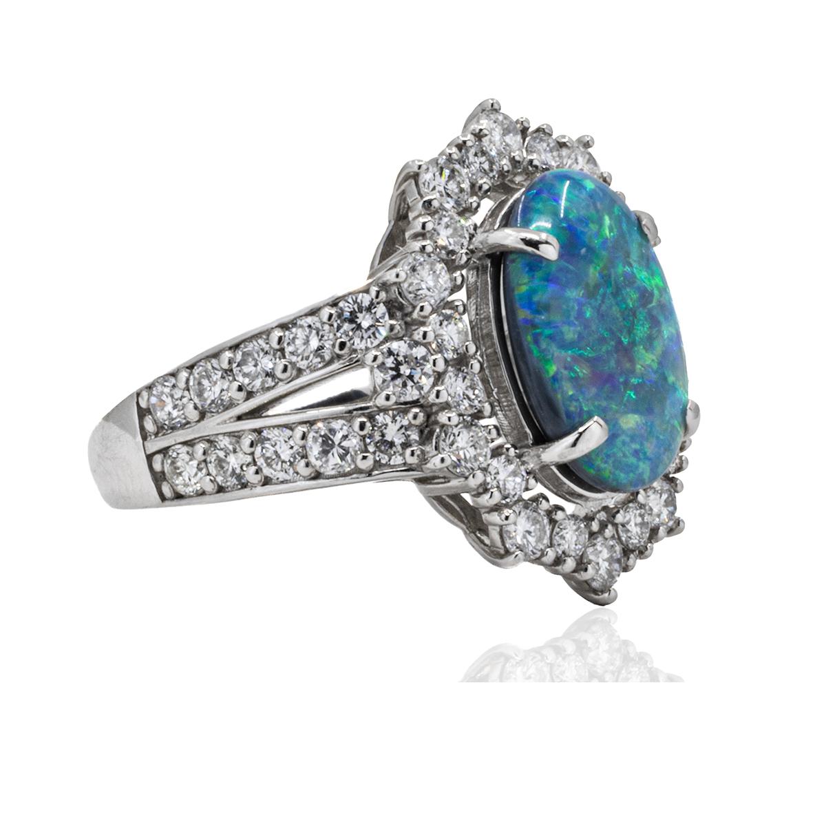 Indulge in the luxurious beauty of our Platinum Black Opal Ring. This exquisite piece features a mesmerizing black opal, radiating with captivating hues, set in a sleek platinum band. A perfect accessory to elevate any outfit and make a statement of