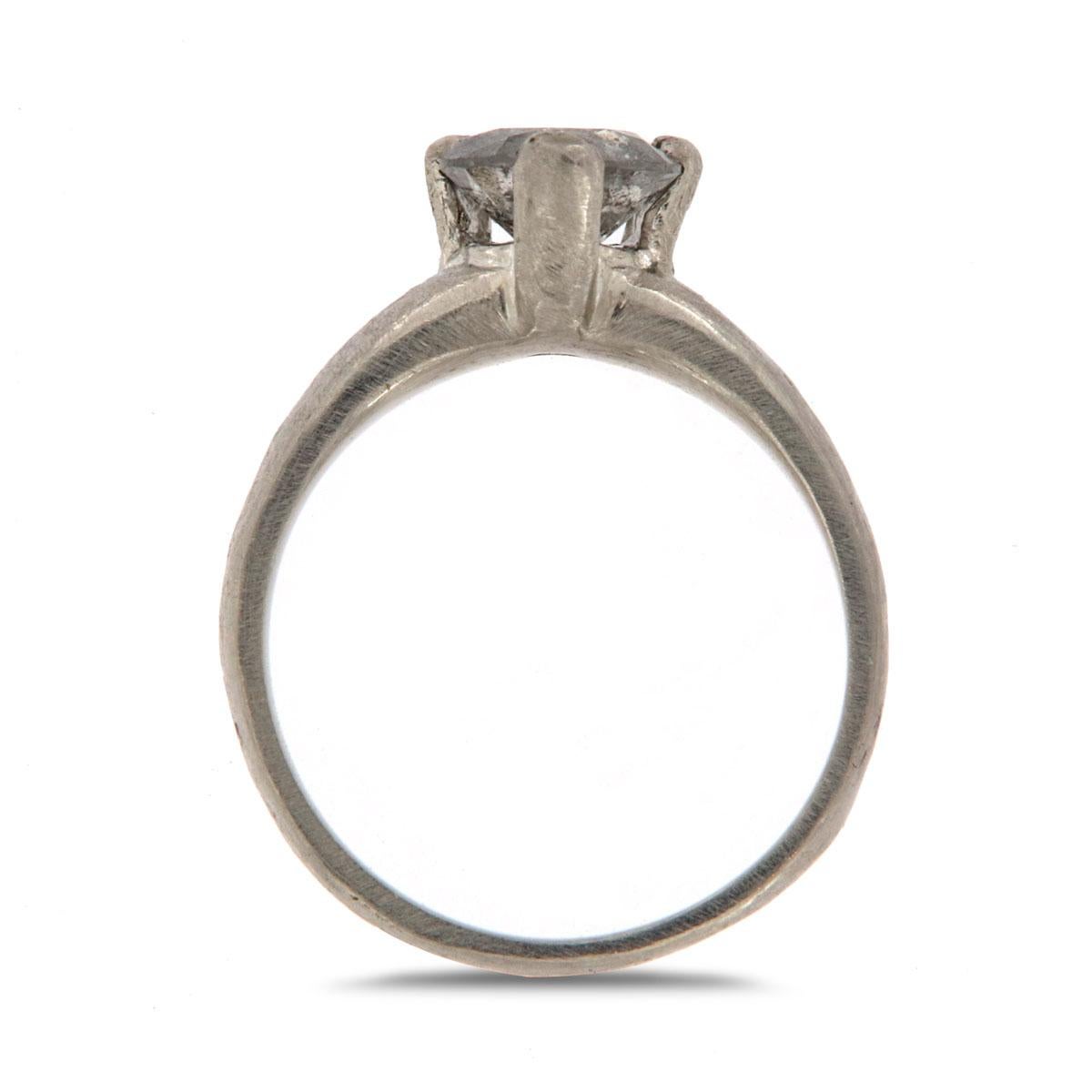 This Unique One-Of-A-Kind ring features a 0.95 carat of round Salt & Pepper natural diamond set in three wide prongs. The slightly hammered shank and its satin finish give it the alluring feeling of mother nature. It's Earthy and organic. Experience