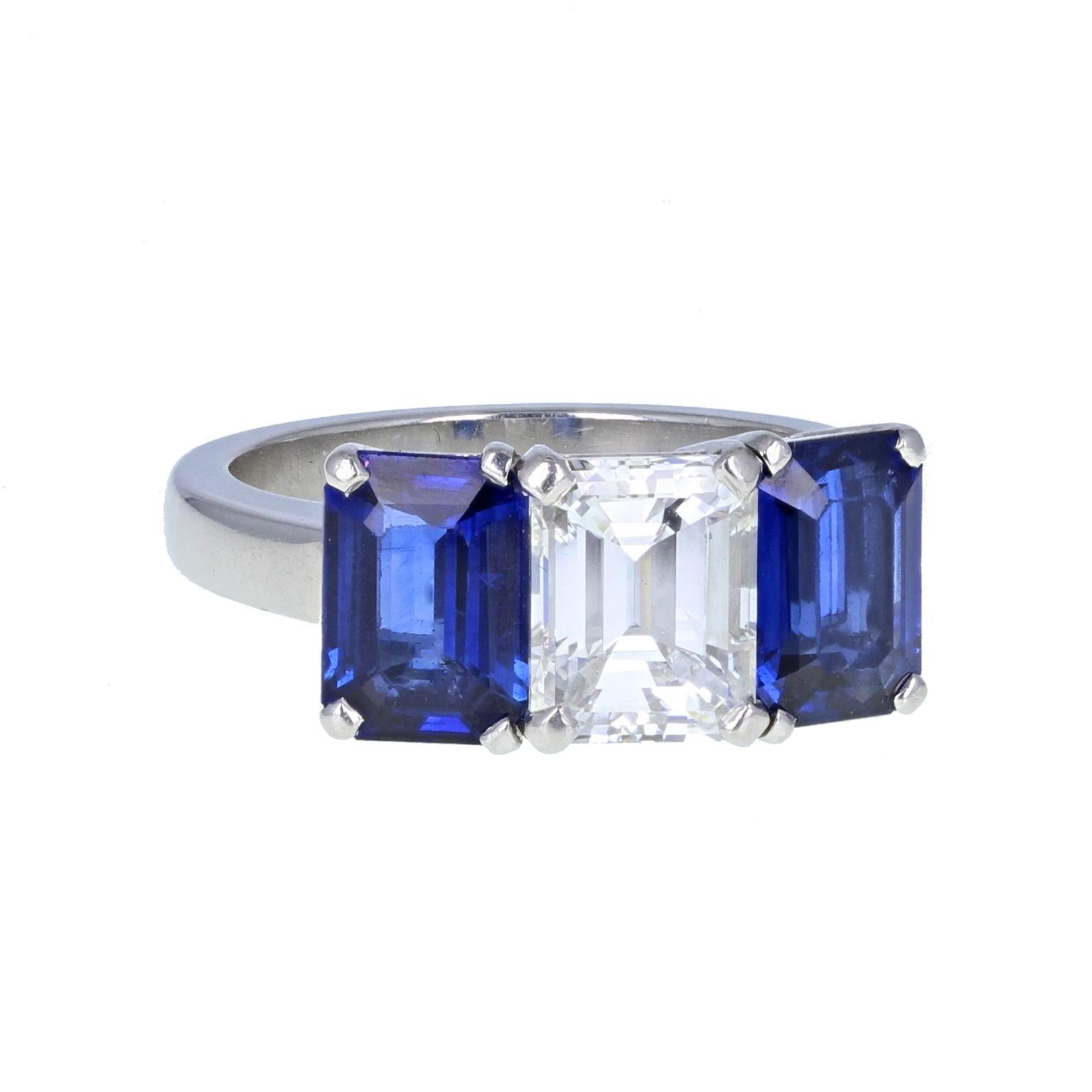 A magnificent blue sapphire and diamond three-stone engagement ring, meticulously well-crafted and exquisitely beautiful  Diamond: 1.60 carats  Diamond Colour: H  Diamond Clarity: VS  Setting: Mounted in four platinum claws and a heavy, squared