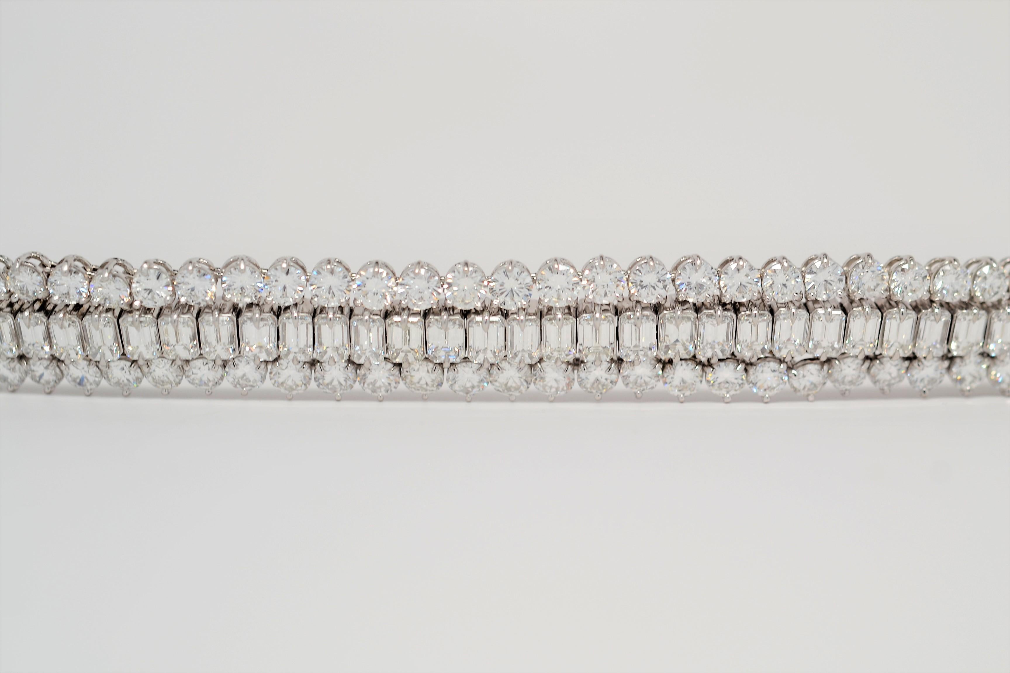 A unique statement piece, this handmade Platinum bracelet is set with Emerald Cut and Round Brilliant Cut Diamonds. A three row layout is set with calibrated Round Brilliant Cut Diamonds on the outside and a center row of Emerald Cut Diamonds. Each