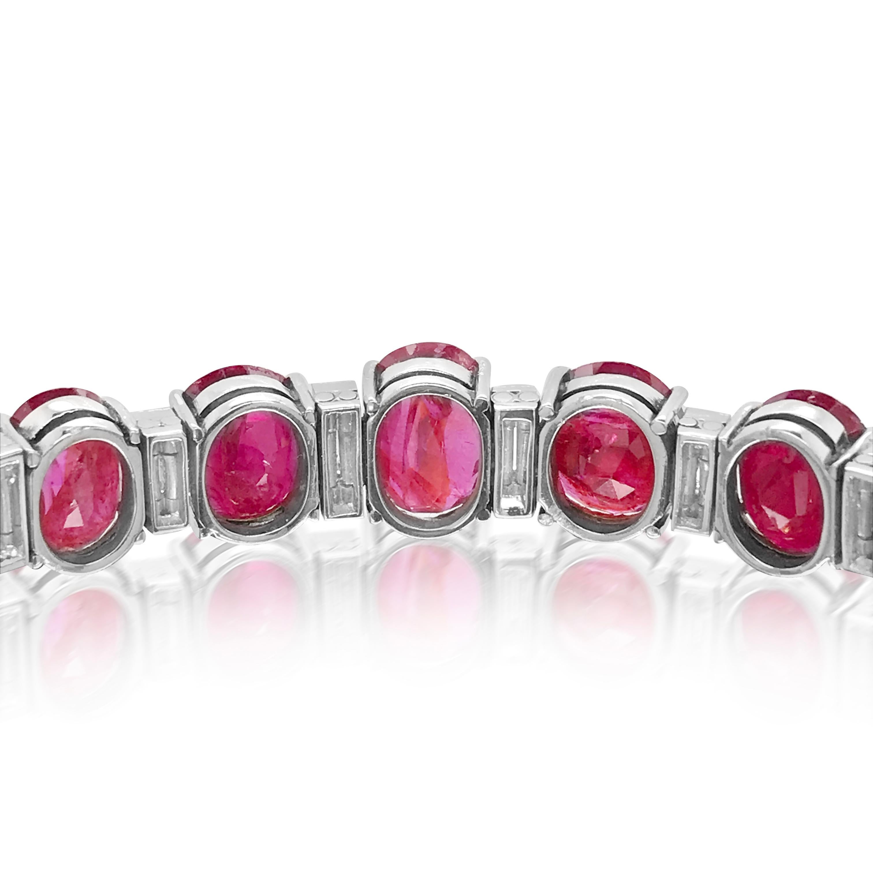 This ruby diamond bracelet crafted in solid platinum weighs 35.42 grams and measures  16.2 cm (6.4 inches) long. The 14 rubies weigh cumulatively 41 carats, linked by 18 baguette-cut diamonds weighing 2.4 carats. 

Ruby total weight: 41ct
Diamond