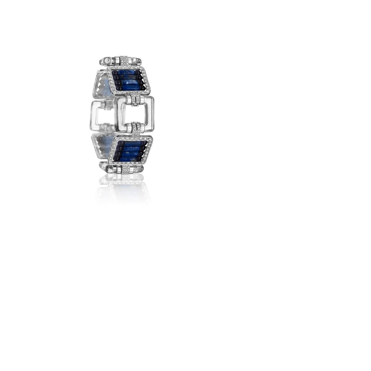 A platinum and black enamel bracelet with diamonds, lapis lazuli and crystal. The strongly designed bracelet features alternating diamond accented crystal frames that display an open feature or diamond studded frames that hold columns of lapis