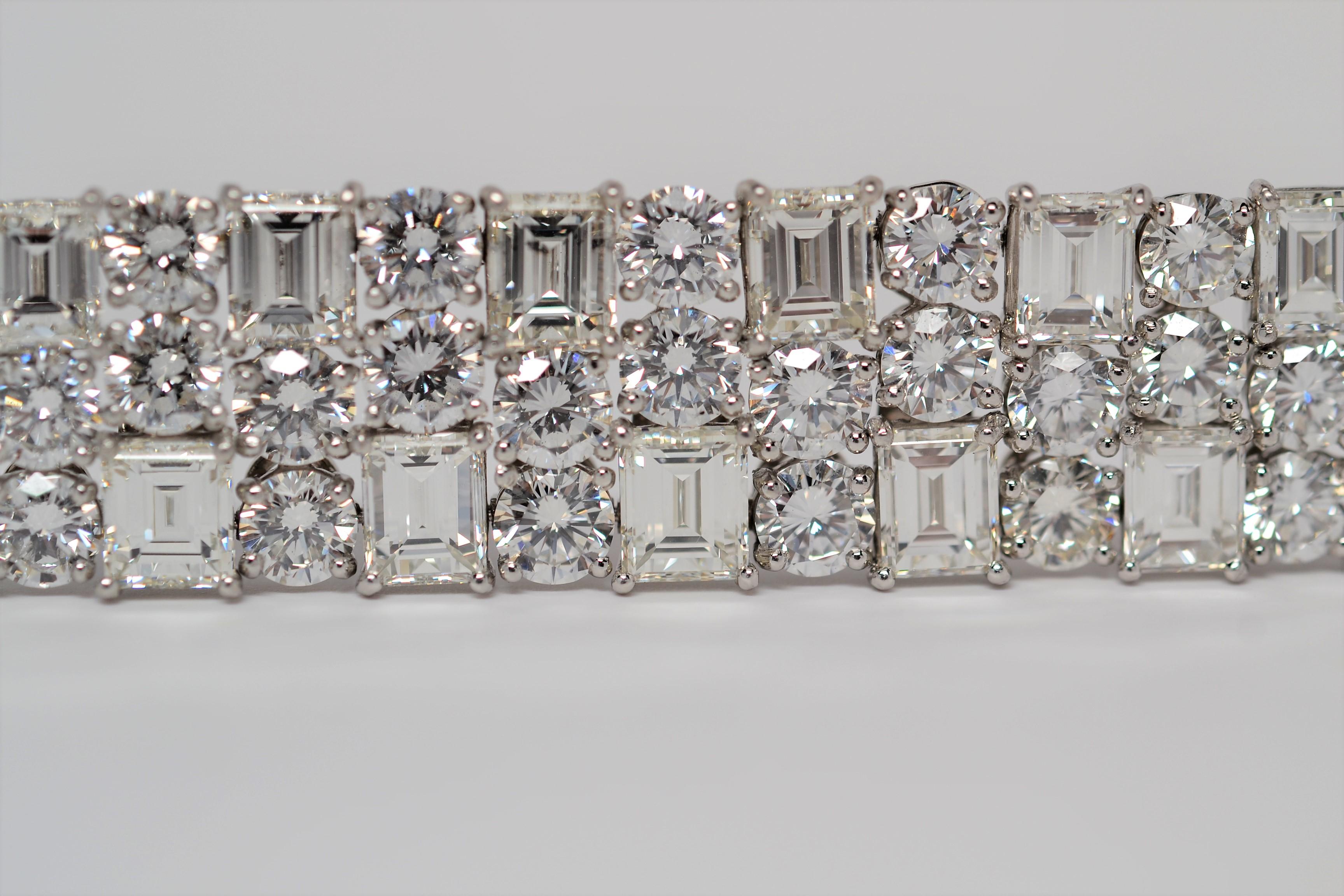 An amazing handmade bracelet set in Platinum with diamonds going all the way around. The Platinum bracelet is a three row layout with a staggered combination of Round Brilliant Cut Diamonds and Emerald Cut Diamonds. Custom made Platinum baskets with