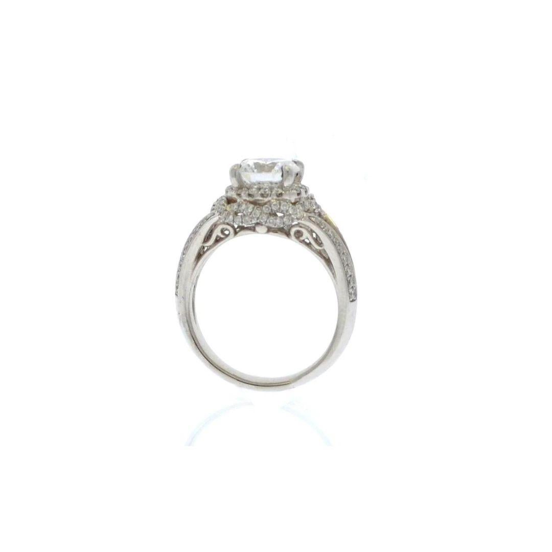 Prominent platinum engagement ring with split shank and beautiful braided diamond halo. Intricate pave diamonds weave through this gorgeous ring creating substantial presence without a heavy feel. Ring contains 0.55 ctw of premium round white