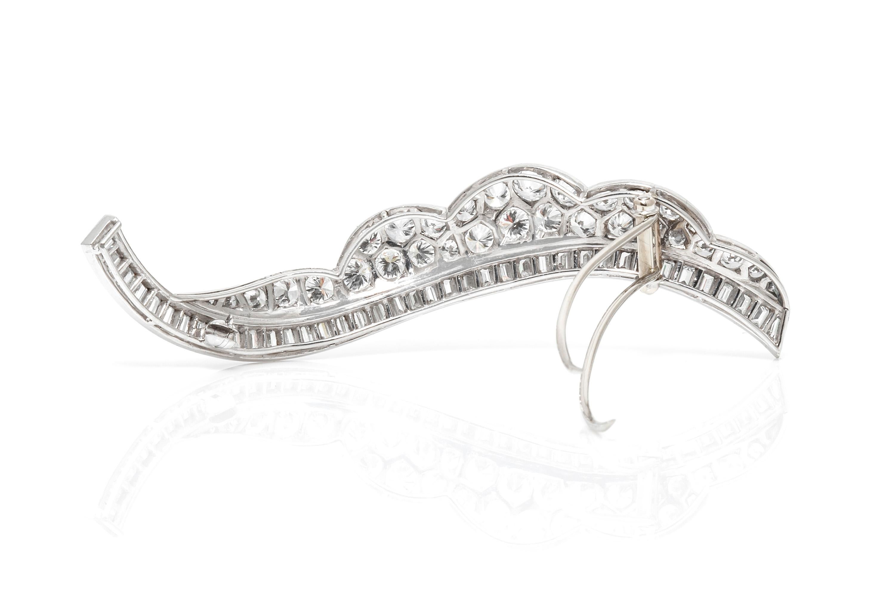 Long Pin, finely crafted in platinum,featuring approximately 5.00 carat round diamond ,and 3.50 carat baguette cut.
