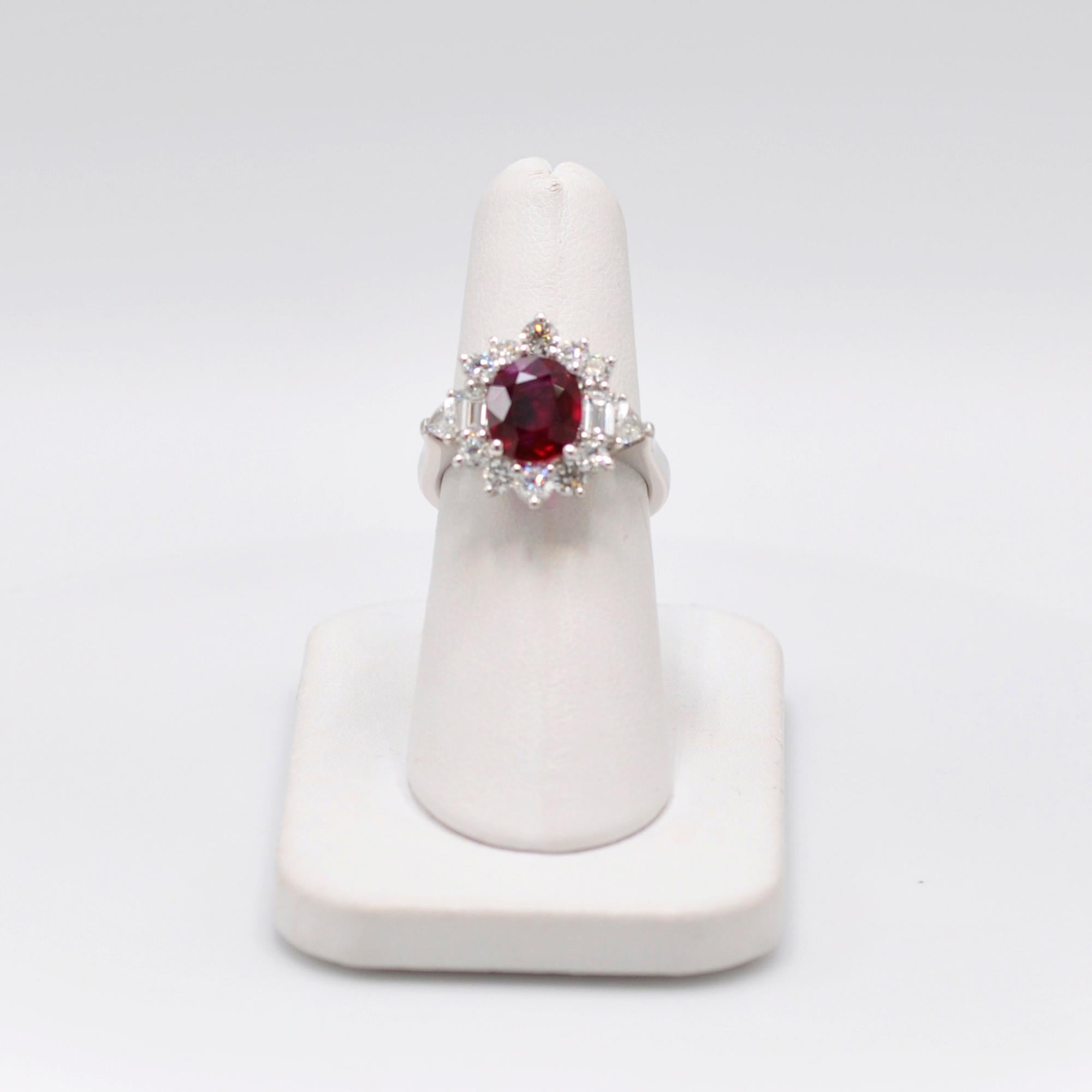 2.01 CT Burma ruby surrounded by .93 CT of round cut diamonds in a platinum setting. 

Stamped ‘Plat’. 

Size 6.5.