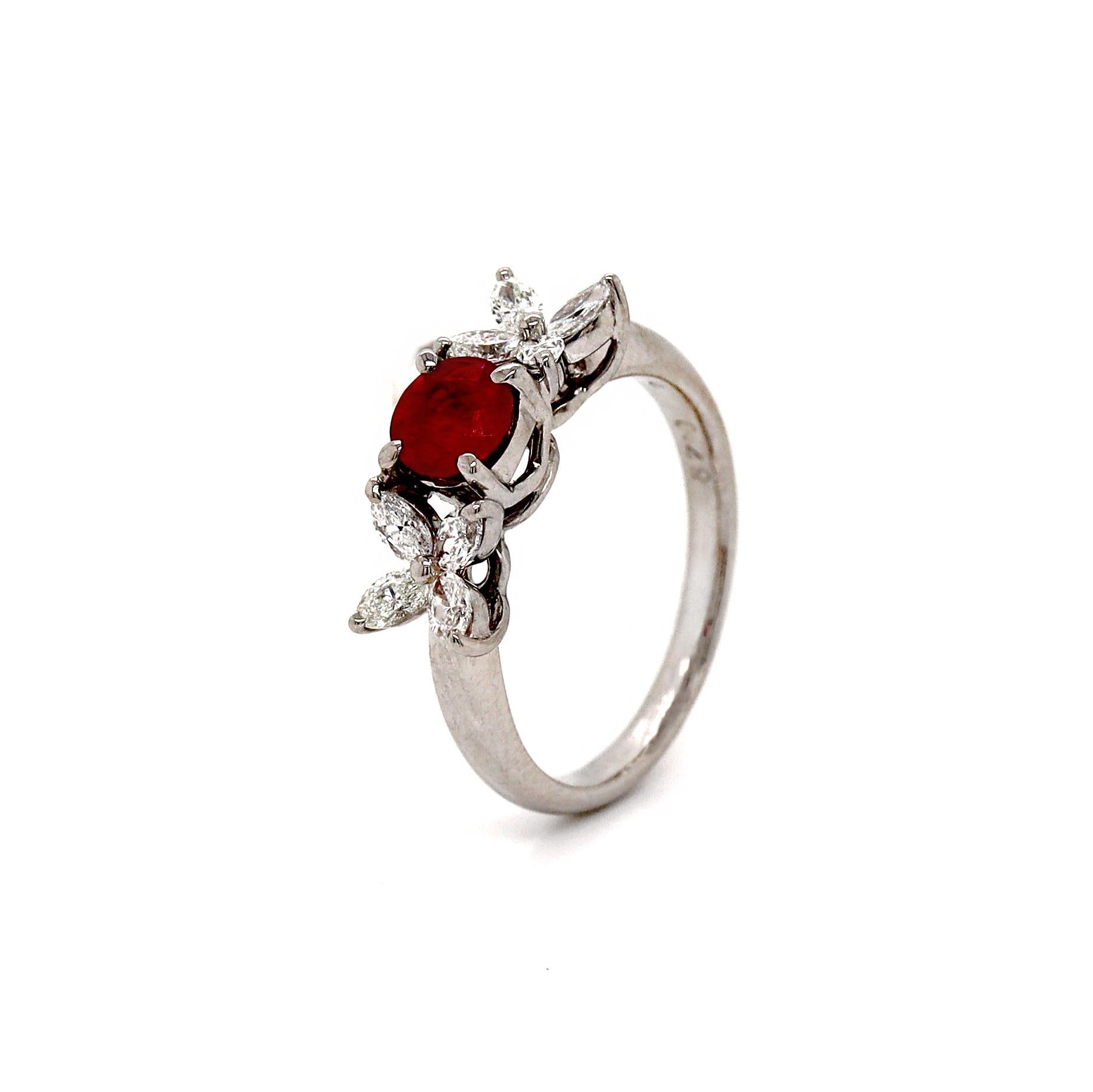 Platinum Burma Ruby & Diamond Ring

This elegant platinum ring showcases a captivating round ruby at its center, flanked by  sparkling marquise-shaped diamonds on either side. The rich red hue of the ruby contrasts beautifully with the brilliant