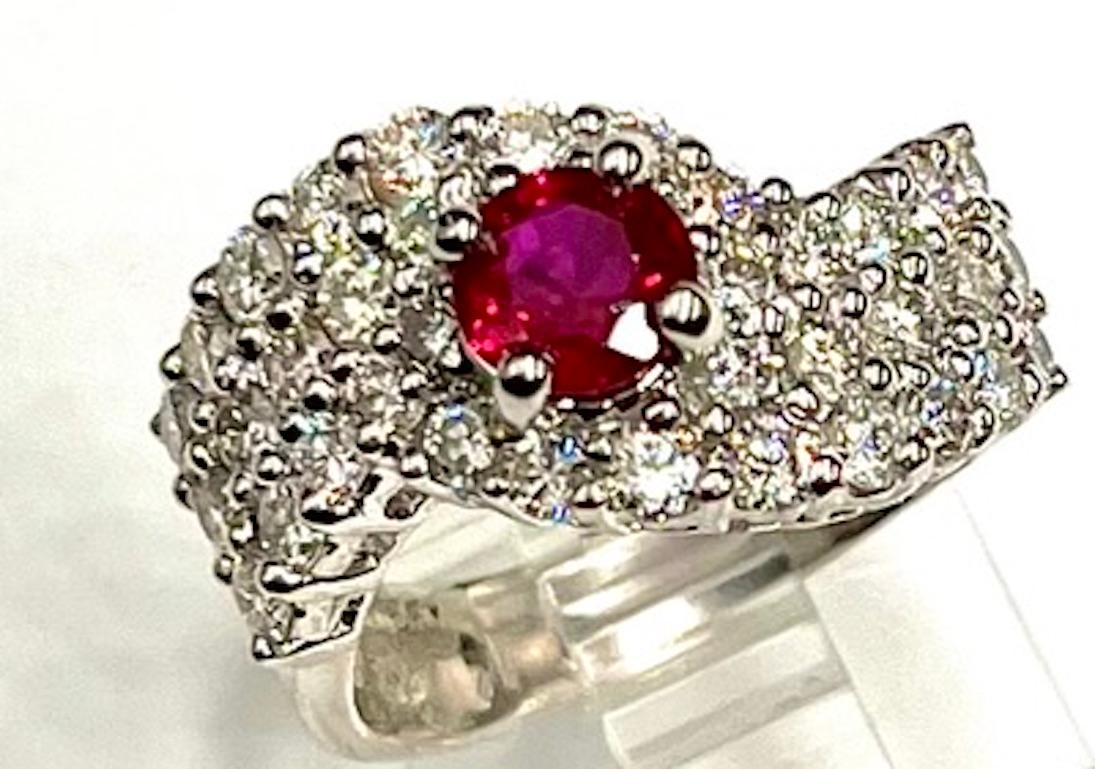 This is a beautiful, impressive ring featuring a .89Ct Fine Oval Burmese Ruby with a deep, rich and highly saturated color that has even distribution. It is complemented by 36 Natural Round White Diamonds of 1.55Ct Total Weight. This ring can serve