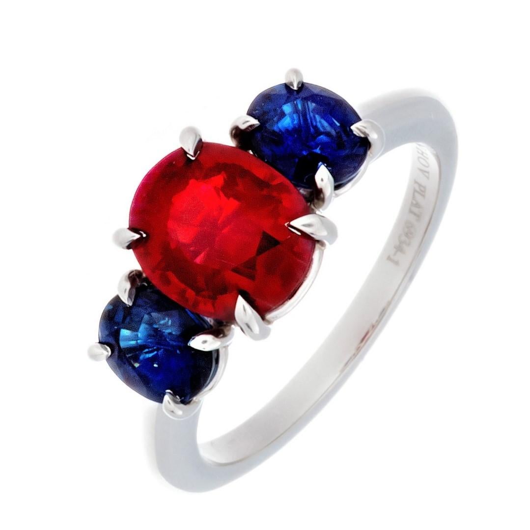 Platinum Burmese Ruby And Sapphire 3-Stone Ring; 
Set With 1..95 Carat Burma Ruby, weighing 1.95 Carats, 
Also Set With 2-Side Blue Sapphires Total 1.43 Carats.
The mounting is hand made of Platinum by Danhov.
Finger Size 6:
This ring can be