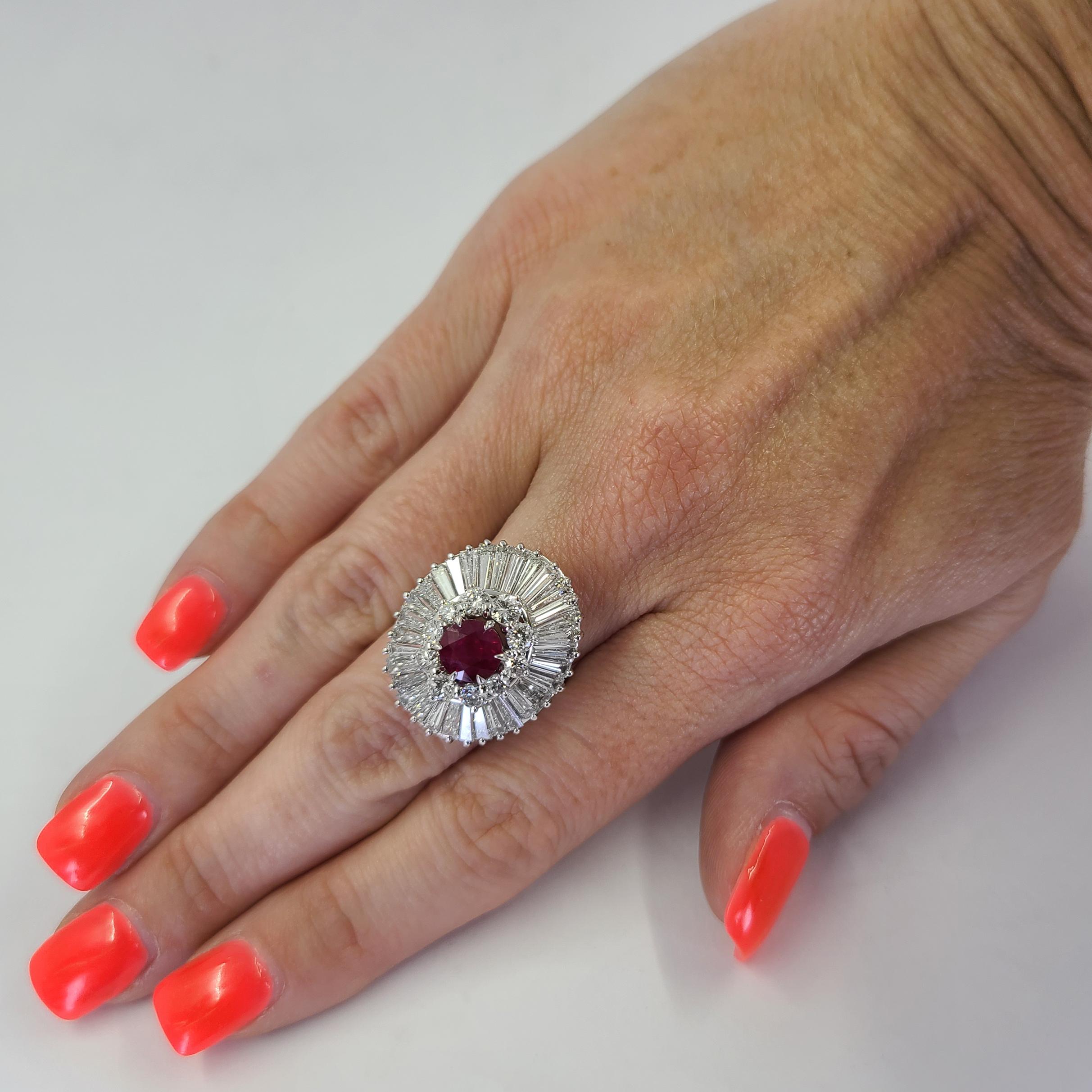 Platinum Ballerina Ring Featuring A 1.30 Carat Round Ruby Surrounded By 6.00 Carat Total Weight Tapered Baguette and Round Diamonds Of VS Clarity and G Color. Finger Size 5.75; Purchase Includes One Sizing Service Prior to Shipment. Finished Weight