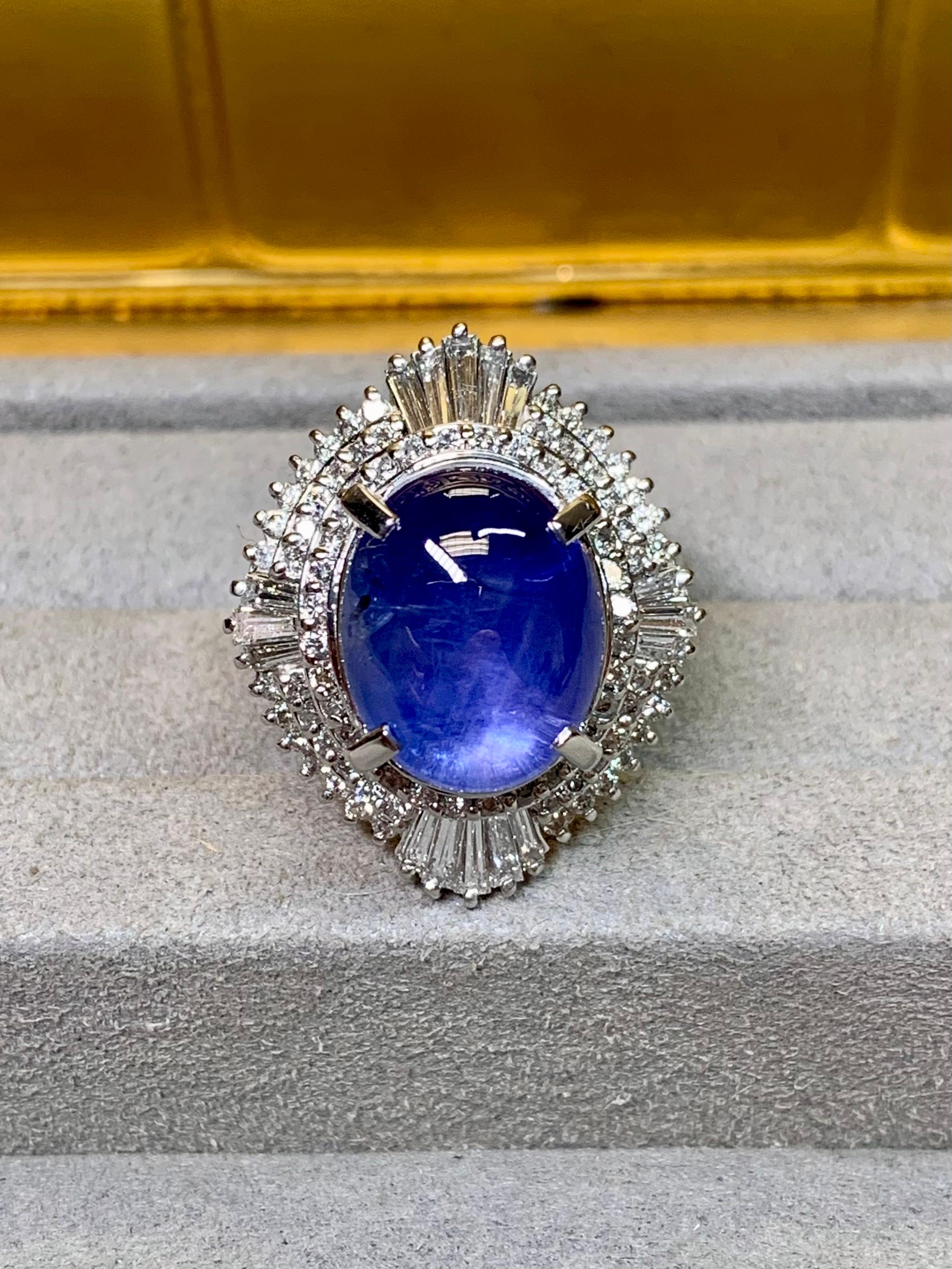 
A gorgeous estate ring done in platinum and centered by an impressive cabochon natural star sapphire exhibiting much better/deeper color than average and a perfect 6 ray star. The center stone weighs 16.70ct. Surrounding the center stone is 1.63ctw