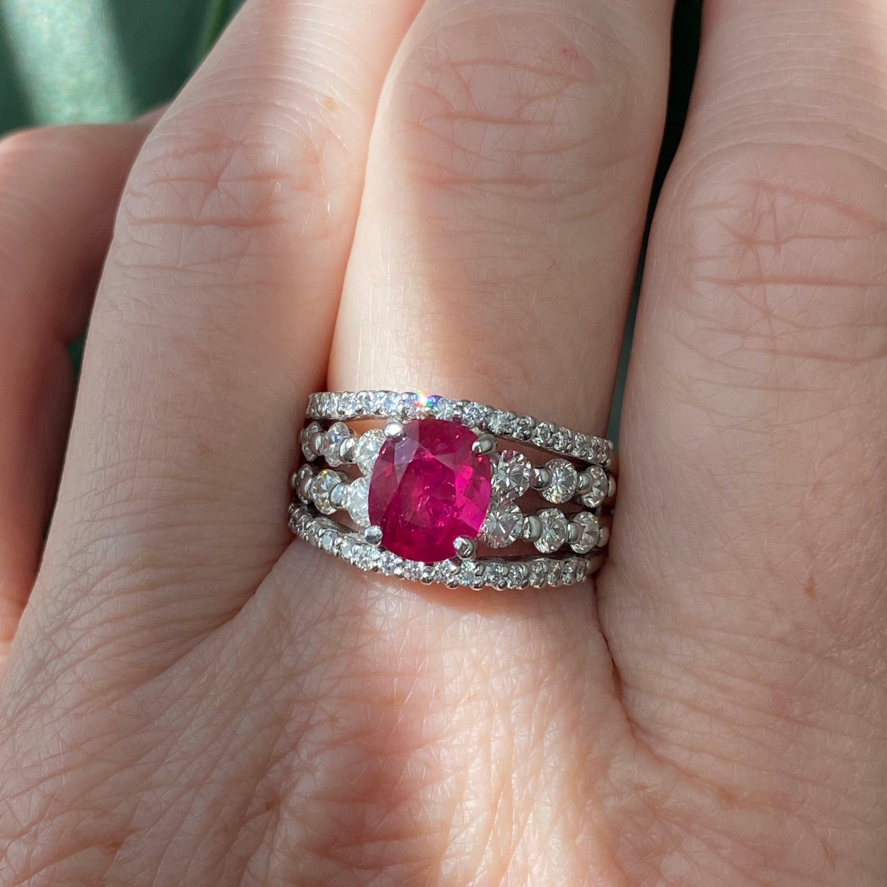 Crafted in platinum, the ring features an oval ruby solitaire set in a graduating wide band style diamond setting. The contrast of the perfect red color and the white diamonds makes this ring truly magical. The ruby just glows in the sunlight.
