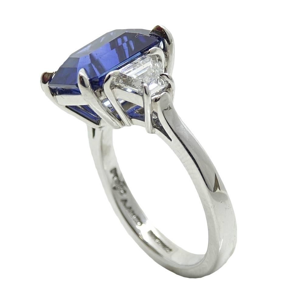 This Heirloom Quality Platinum Ring Has An Eyecatching Heated Ceylon Sapphire Set In The Center Weighing A Total Carat Weight Of 6.36 Carats. Two Tapered Baguette Cut Diamonds Are Set On The Side Of The Sapphire and Weigh A Total Carat Weight Of