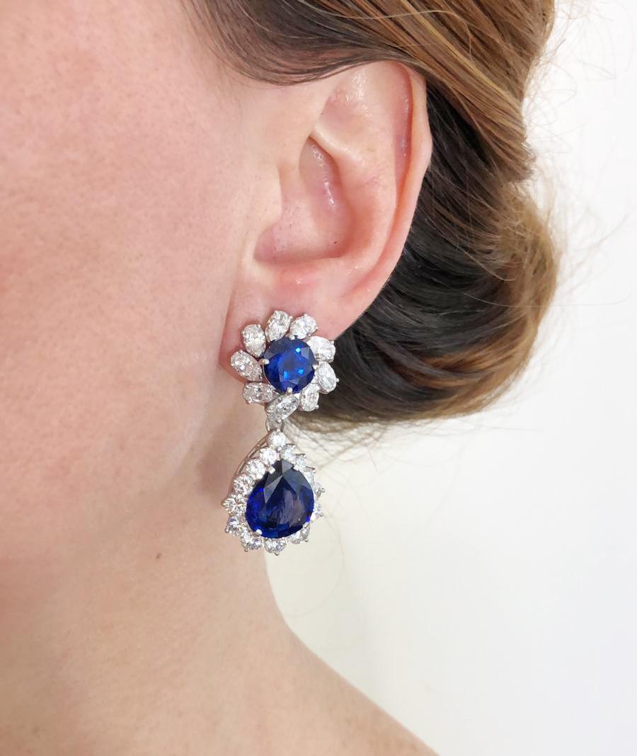 Contemporary Sapphire Diamond Detachable Drop Earrings in Platinum.

A classic pair of drop on-the-ear clips featuring round faceted sapphires with pear-shaped sapphires, surrounded with halos of graduated round brilliant diamonds. The depth of