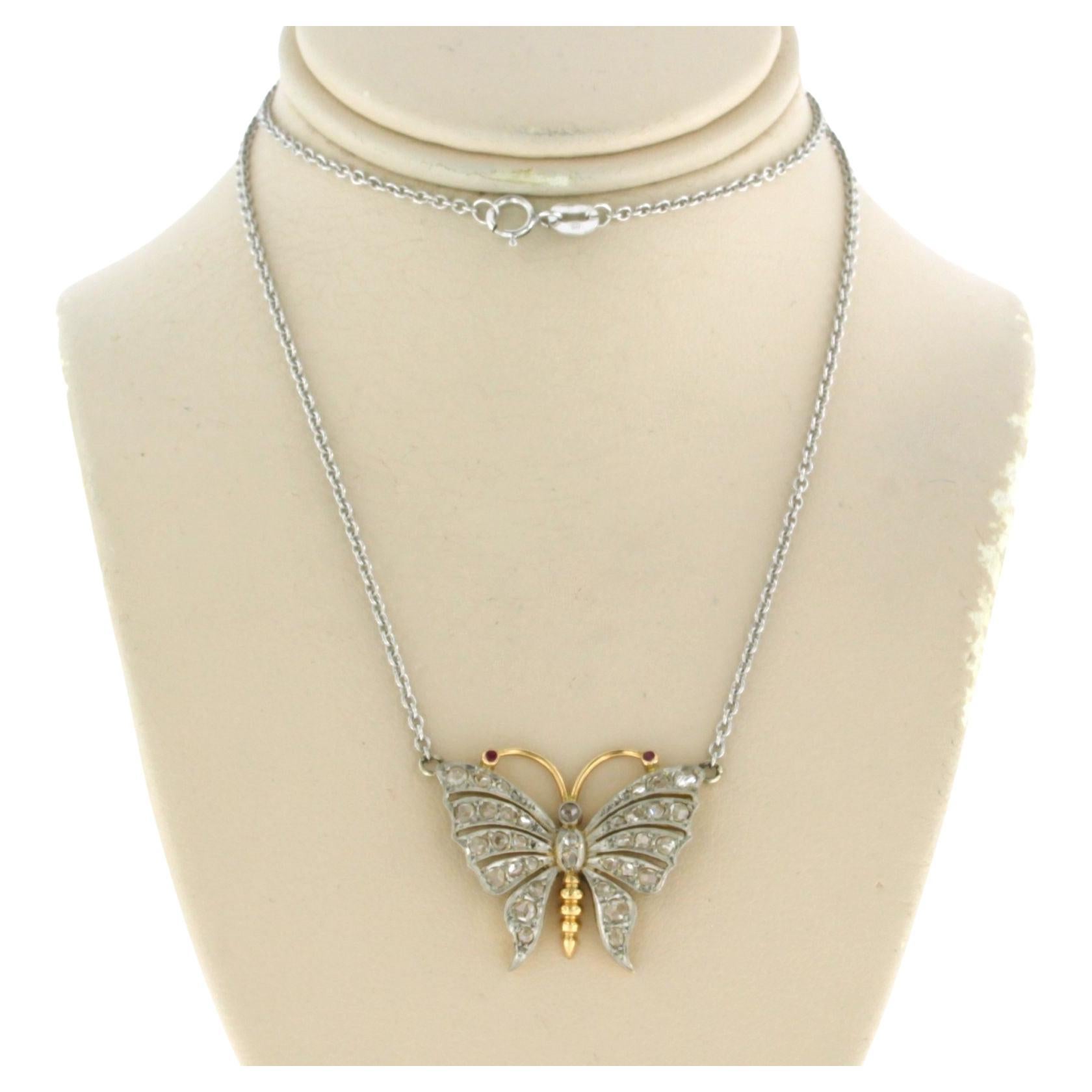 Platinum chain and a gold and platinum butterfly pendant with diamonds and ruby