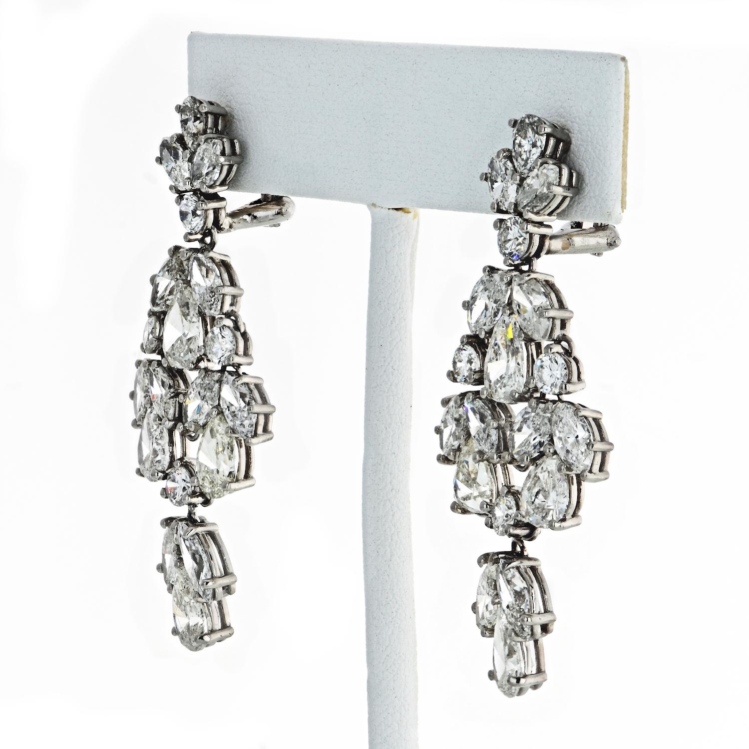 A pair of American Mid-20th Century platinum chandelier earrings with 20 carats worth of diamonds. The articulated earrings have 10 pear-cut diamonds, 8 round brilliant cuts, 20 marquise cuts, and 20 round-cut diamonds. These earrings give out an