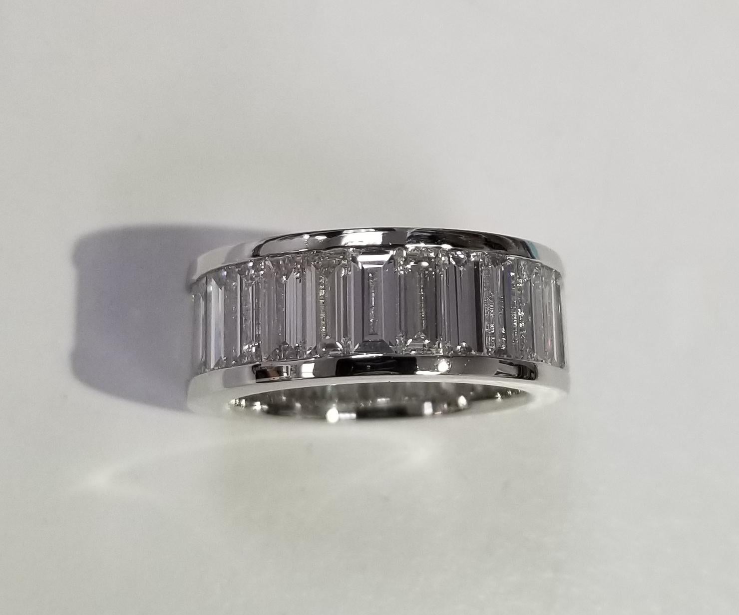 A breathtakingly beautiful diamond wedding band featuring 27 baguette cut diamonds set in Platinum weighing 7.51cts.carats. These spectacular diamonds are F-G in color, VS1  clarity. This seamless eternity band is expertly crafted surely will catch