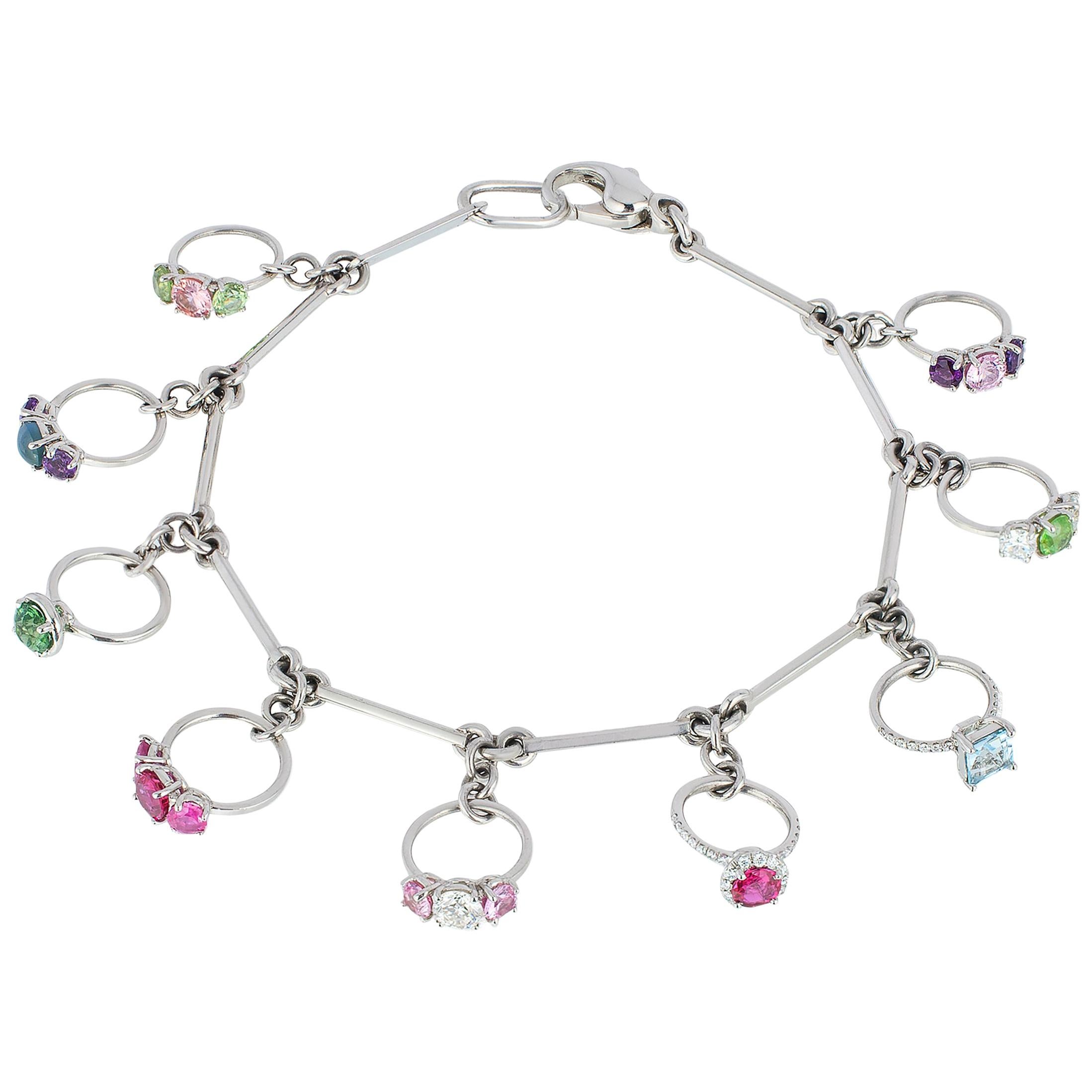 Platinum Charm Bracelet with Miniature Rings Diamonds and Colored Gemstones For Sale