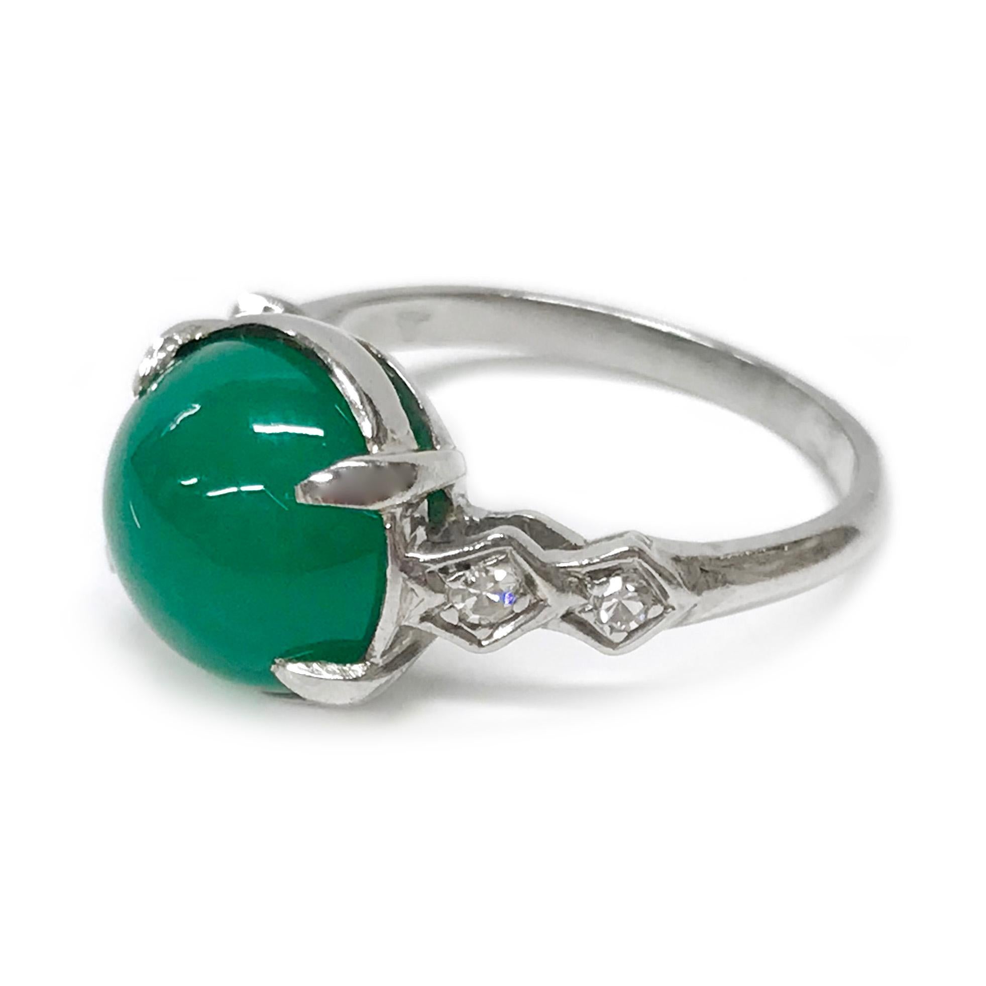 Platinum Chrysoprase Diamond Ring. The ring features a bezel-set round vivid green cabochon measuring 9.4mm with four round bead-set diamonds. The total carat weight of the diamonds is 0.10cts. The ring size is 4 1/2. The total gold weight is 3.9