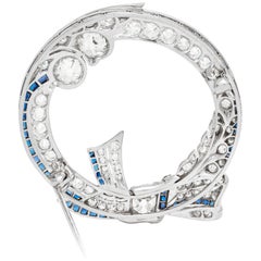 Antique Platinum Circle with Bow Tie with Diamond and Sapphire