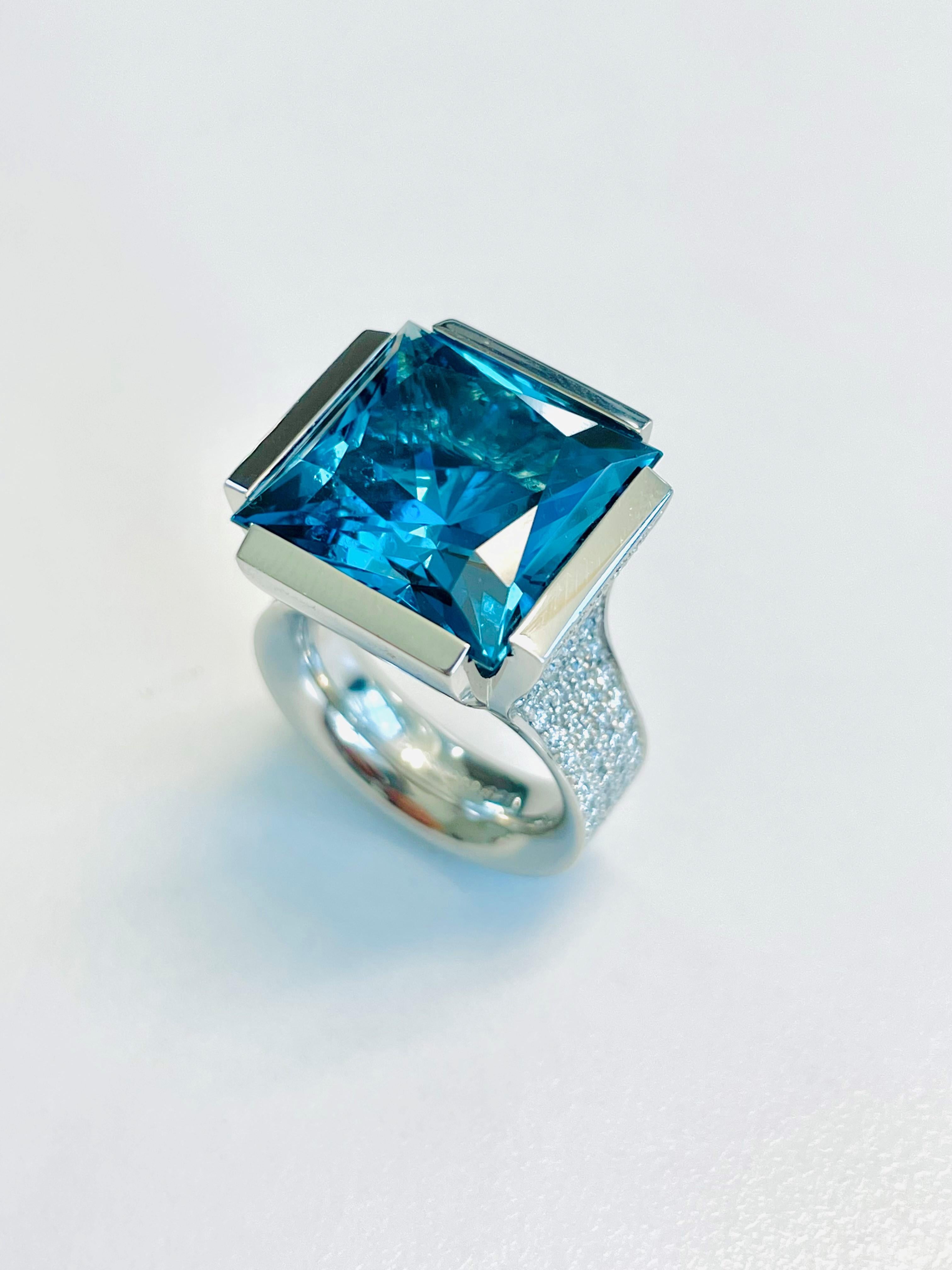 Platinum Cocktail Ring with a stunning Blue Topaz (15x15mm) Princess Cut and 164 brilliant cut diamonds F-vs with a total of 1.75ct. 
This ring was handmade by Henrich & Denzel the platinum manufactory at Lake Constance in Germany. 
Henrich & Denzel