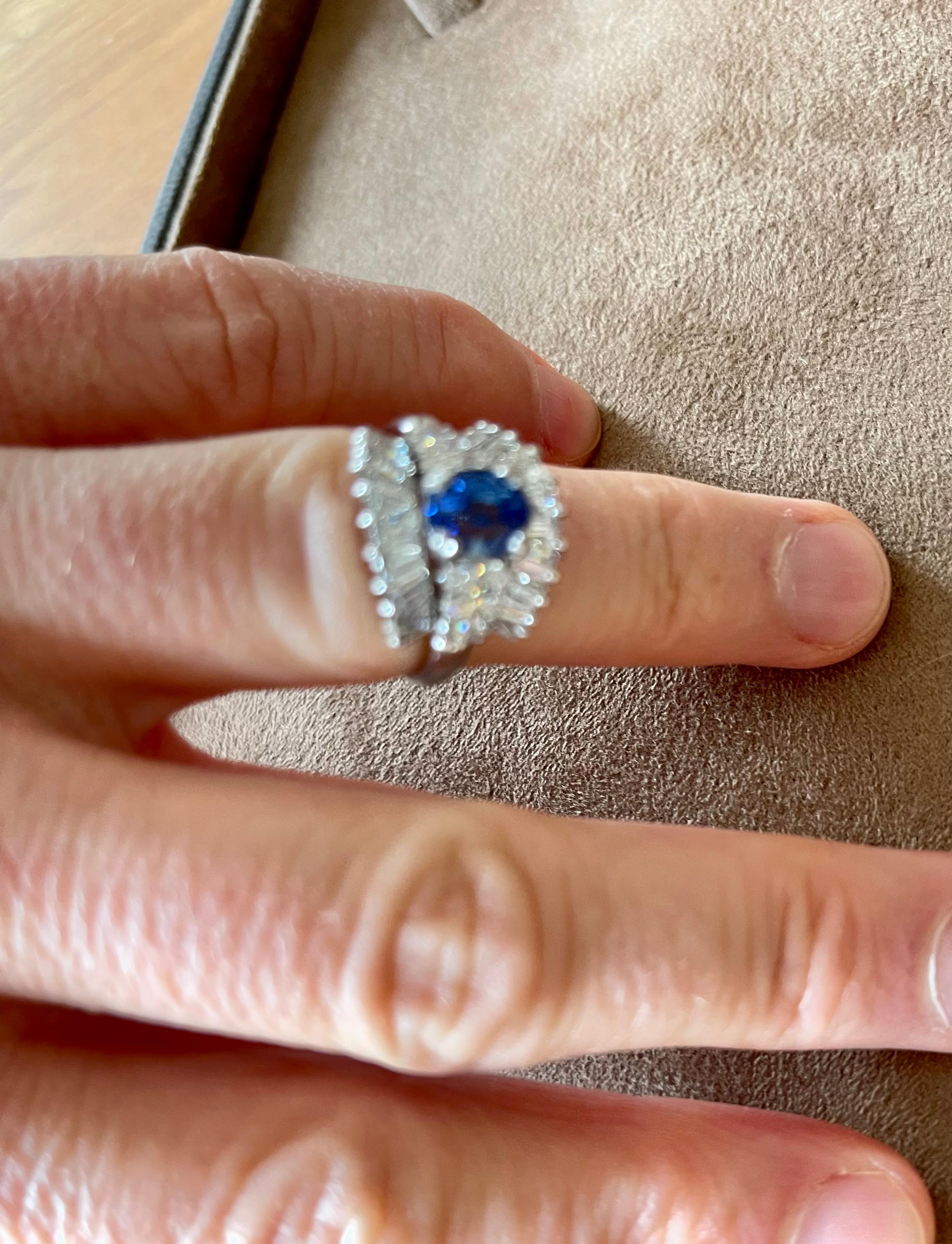 Beautriful and timeless Platinum 950 Cocktail Ring featuring 1 fine cornflower blue Ceylon Sapphire weighing ca 1 ct, flanked by 3 marquise shape Diamonds on each side weighing approximately 0.5 ct and 22 tapered baguette Diamonds weighing
