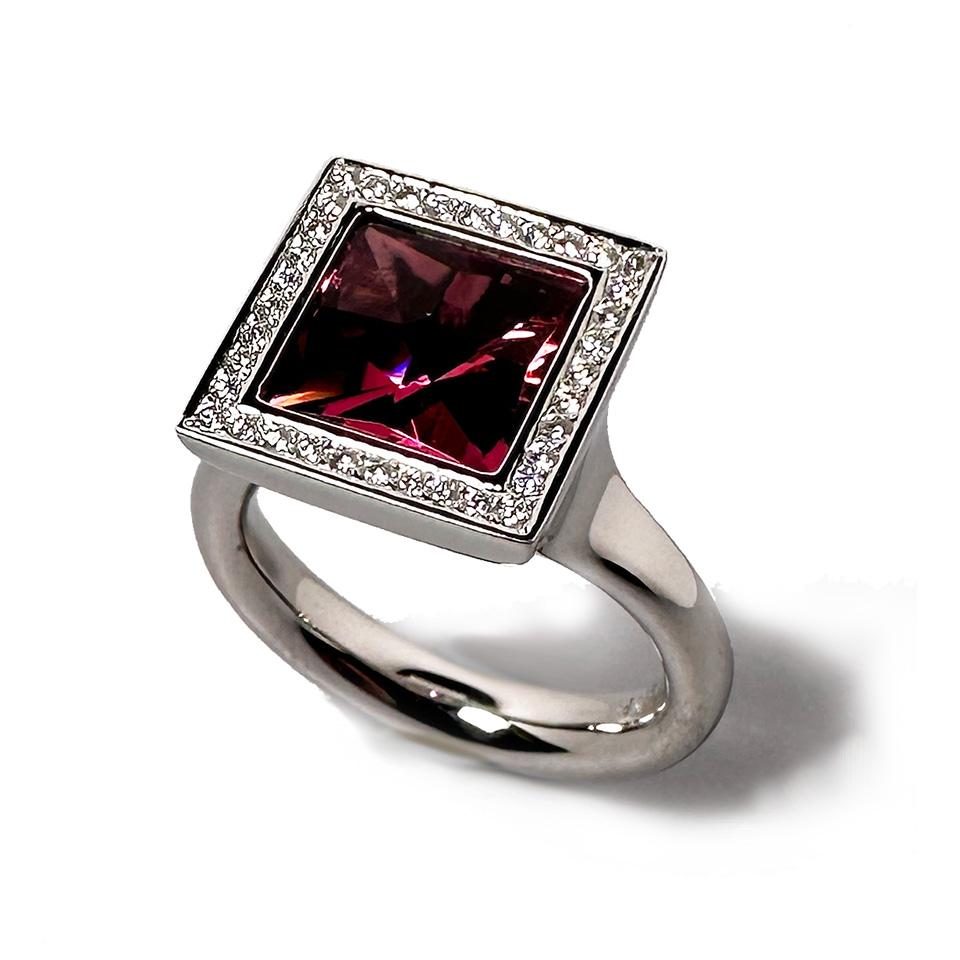 Platinum Cocktail Ring with a beautiful Pink Tourmaline in Carrée Cut and 36 brilliant cut diamonds F-vs with a total of 0.16ct. 
This ring was handmade by Henrich & Denzel the platinum manufactory at Lake Constance in Germany. 
Henrich & Denzel
